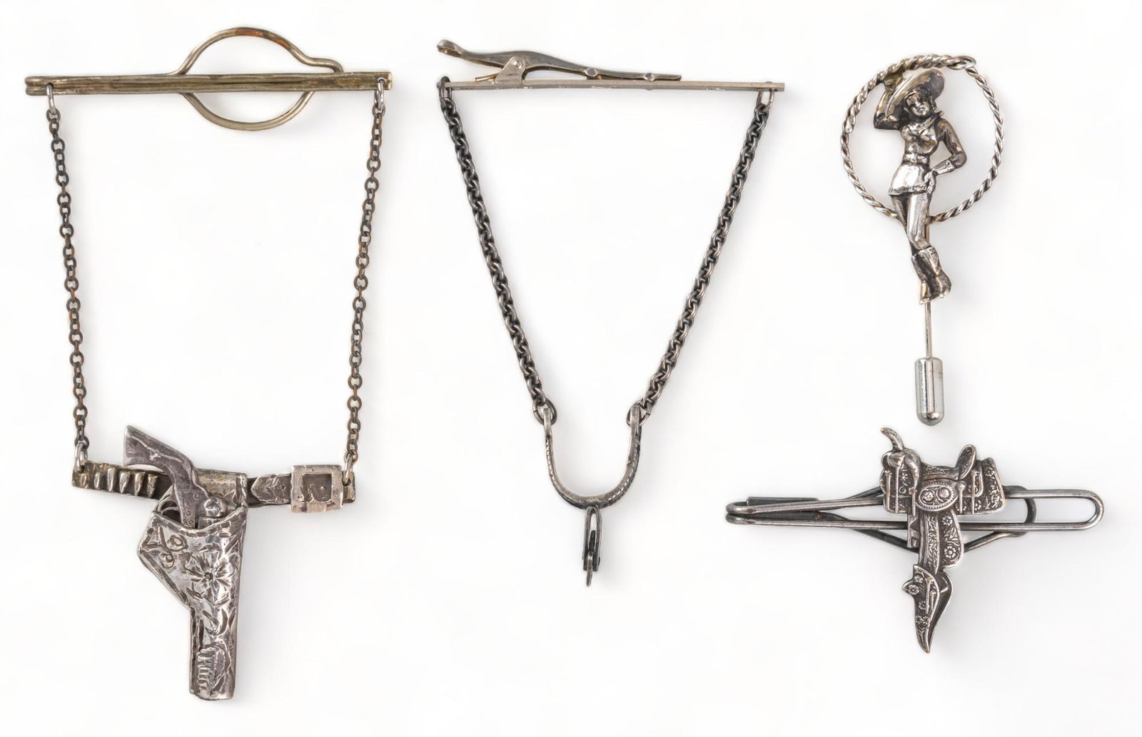 (4) Western Tie Clips and Pin: Four (4) Western tie clips and pin, one (1) sterling silver gun holster rope tie clip, one (1) spur chain tie clip, one (1) saddle tie clip, one (1) cowgirl rope pin gun clip / length 4 in. spur clip 