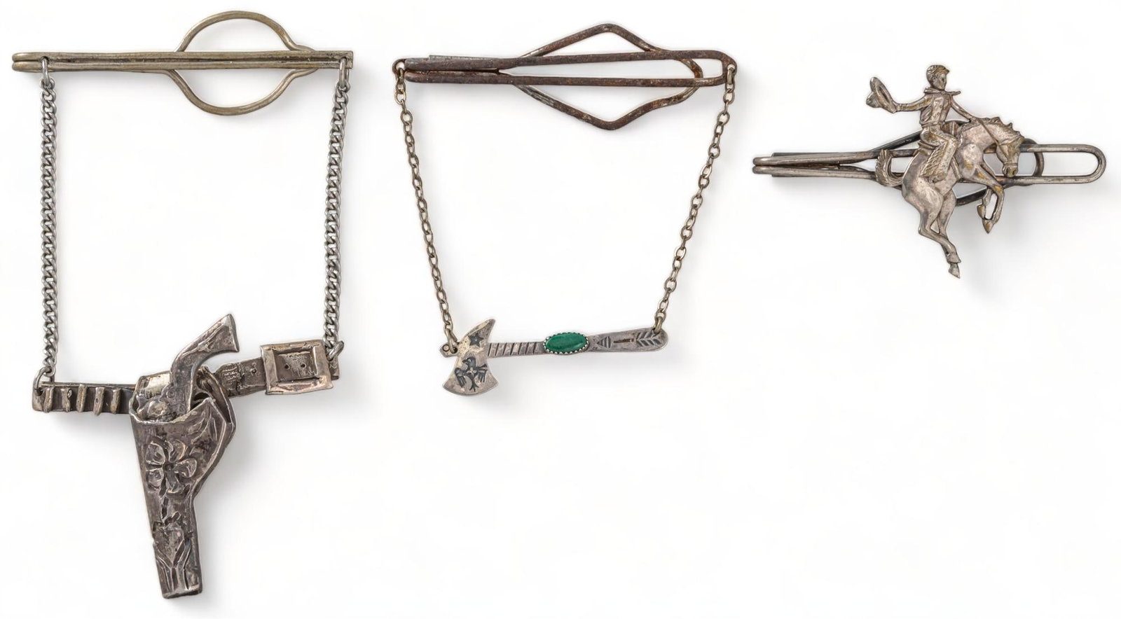 (3) Western Tie Clips: Three (3) Western tie clips, one (1) sterling silver gun holster chain tie clip, marked, one (1) sterling silver and turquoise Native American axe chain tie clip, marked, one (1) bucking bronco tie cl