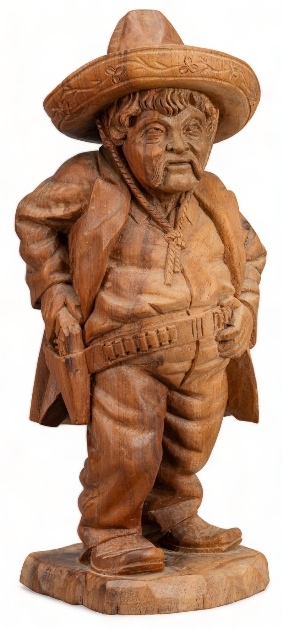 Vintage Hand Carved Folk Art Man: Vintage hand-carved folk art man wearing sombrero and bandolier, reaching for pistol, not marked/signed, freestanding wooden sculpture height 17 in. width 7 in. x depth 5 in. Provenance: A Lytle, Texa