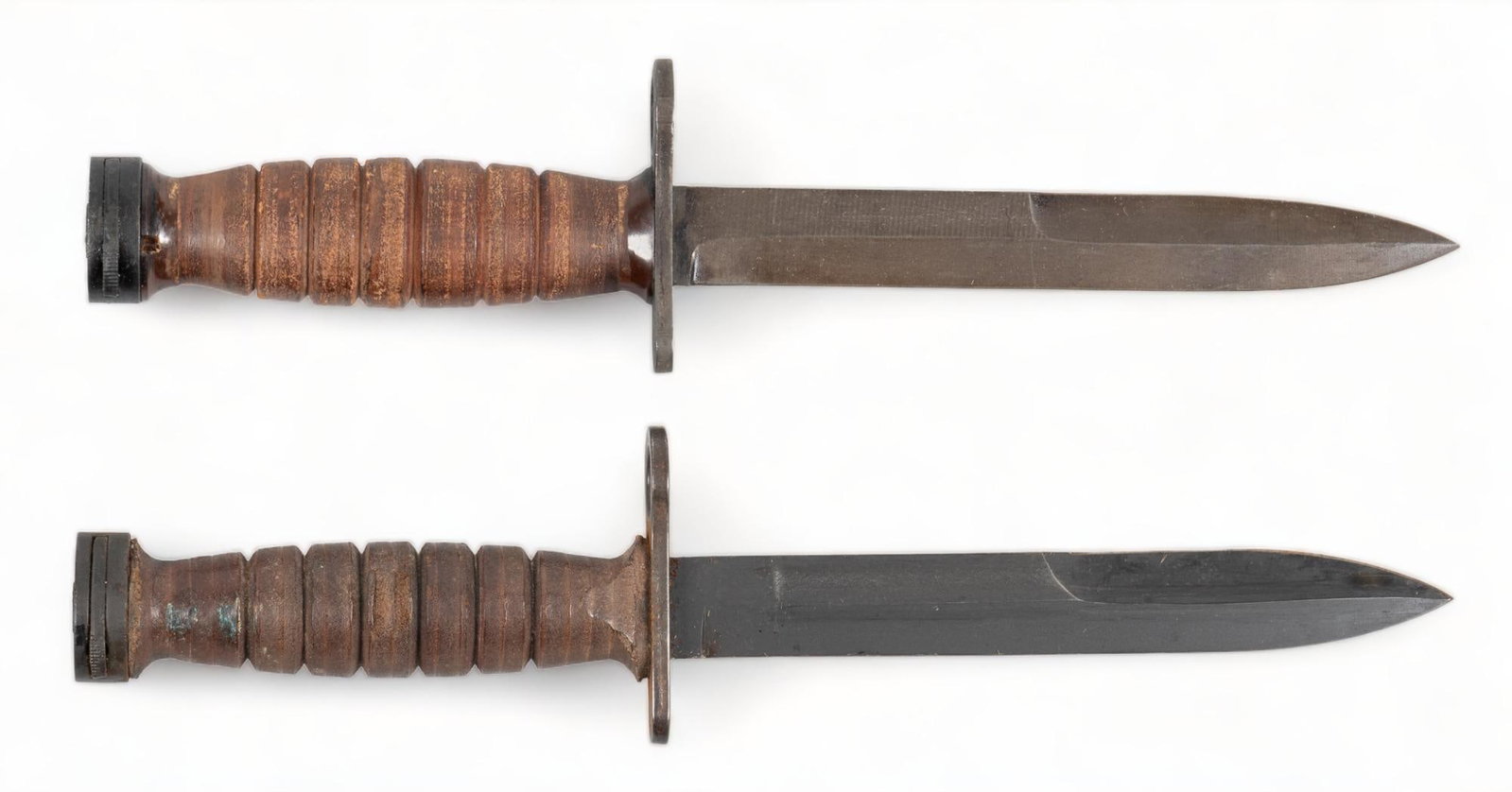 Pair of US M4 Bayonets PAL & Camillus W/ Scabbards: Manufacturer: (1) PAL; (2) Camillus Model: M4 Blade Length: 6.75 in. OAL: 11.75 in. Condition: both are Good; moderate handling marks throughout; light blade wear; moderate scabbard wear Provenance: A