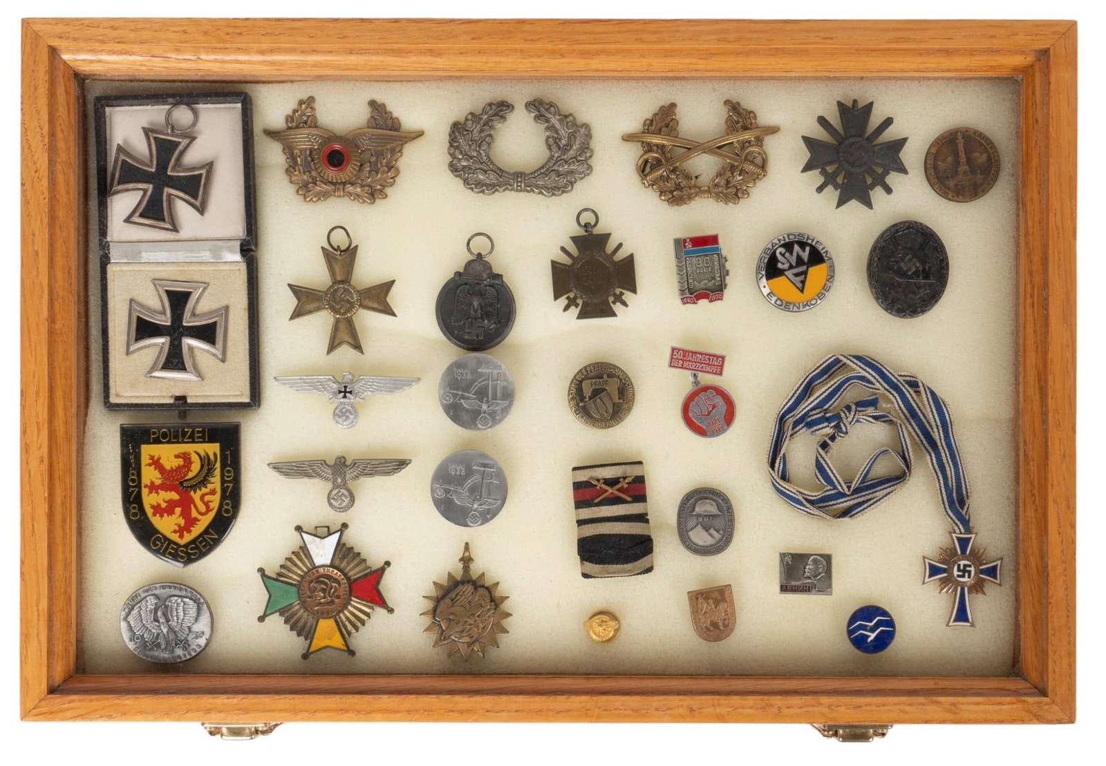 Collection of WWII German Militaria: Includes: -2 x 1939 Iron Crosses -German wreath hat pins -wound badge -Cross of Honour -Soviet pins -Polish Polzei centennial medallion -US Air medal Case Dimensions: 18 x 12 x 2.25 in.