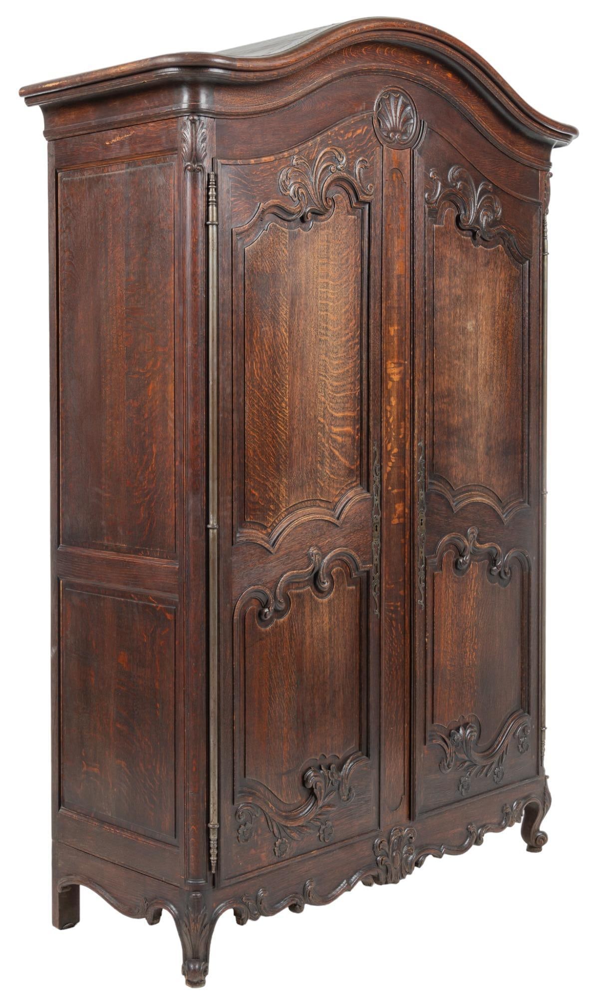 French Provincial Armoire: French provincial armoire, with arched crest, above two panel doors, with carved scrolled accents, opening to interior storage space, above skirt with scrollwork, rising on cabriole legs height 90 in.