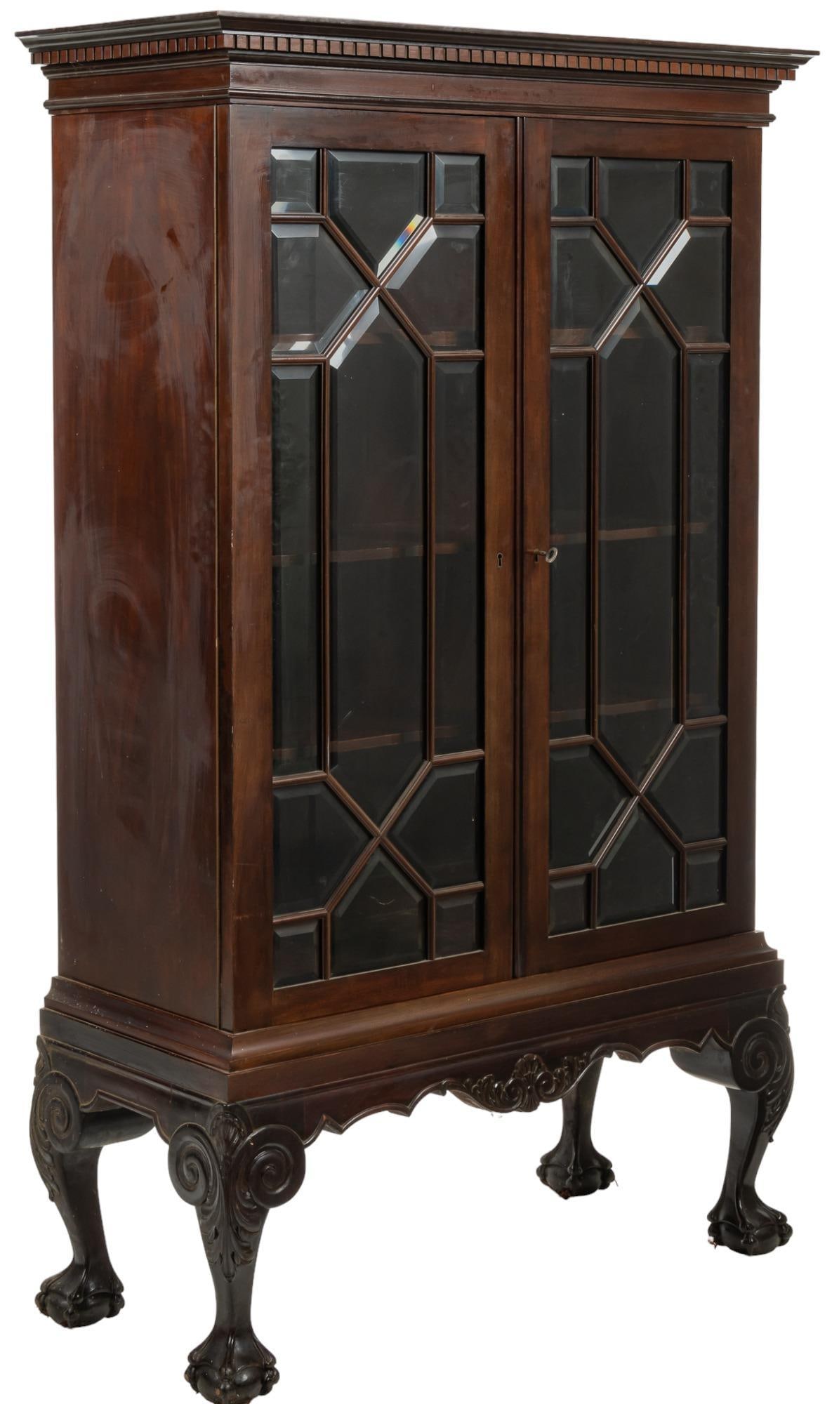 Chippendale Style Display Cabinet: Chippendale style display cabinet, with oversize mantel, glazed doors. featuring beveled glass panels, opening to interior shelving, supported on claw and ball feet, to include key height 82 in. x wid