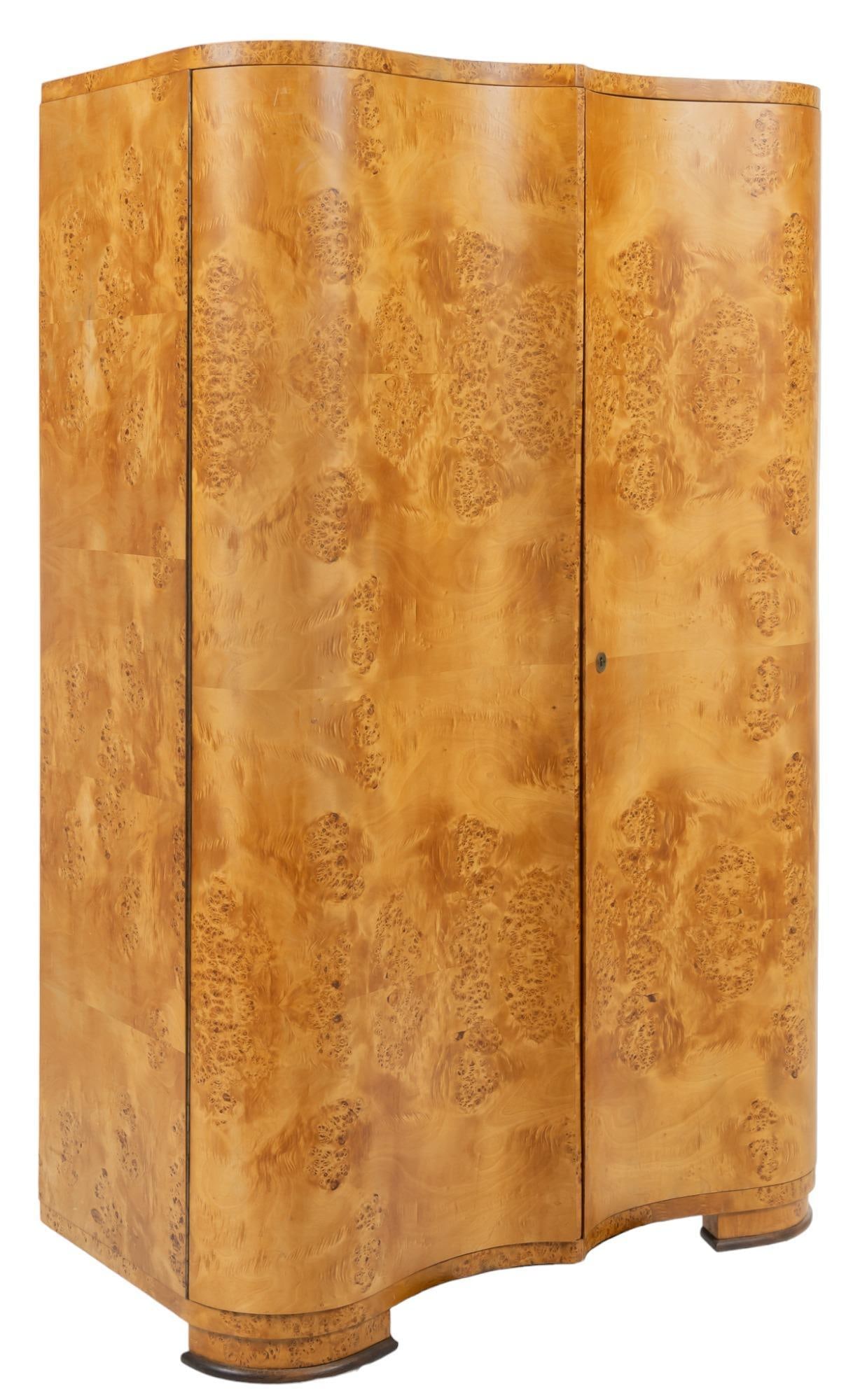 Art Moderne Burlwood Cabinet: Art Moderne burlwood cabinet, with serpentine cabinet doors, supported on block feet height 71 in. x width 45 in. x depth 23 in. We happily provide seamless shipping services on everything we sell. Pl