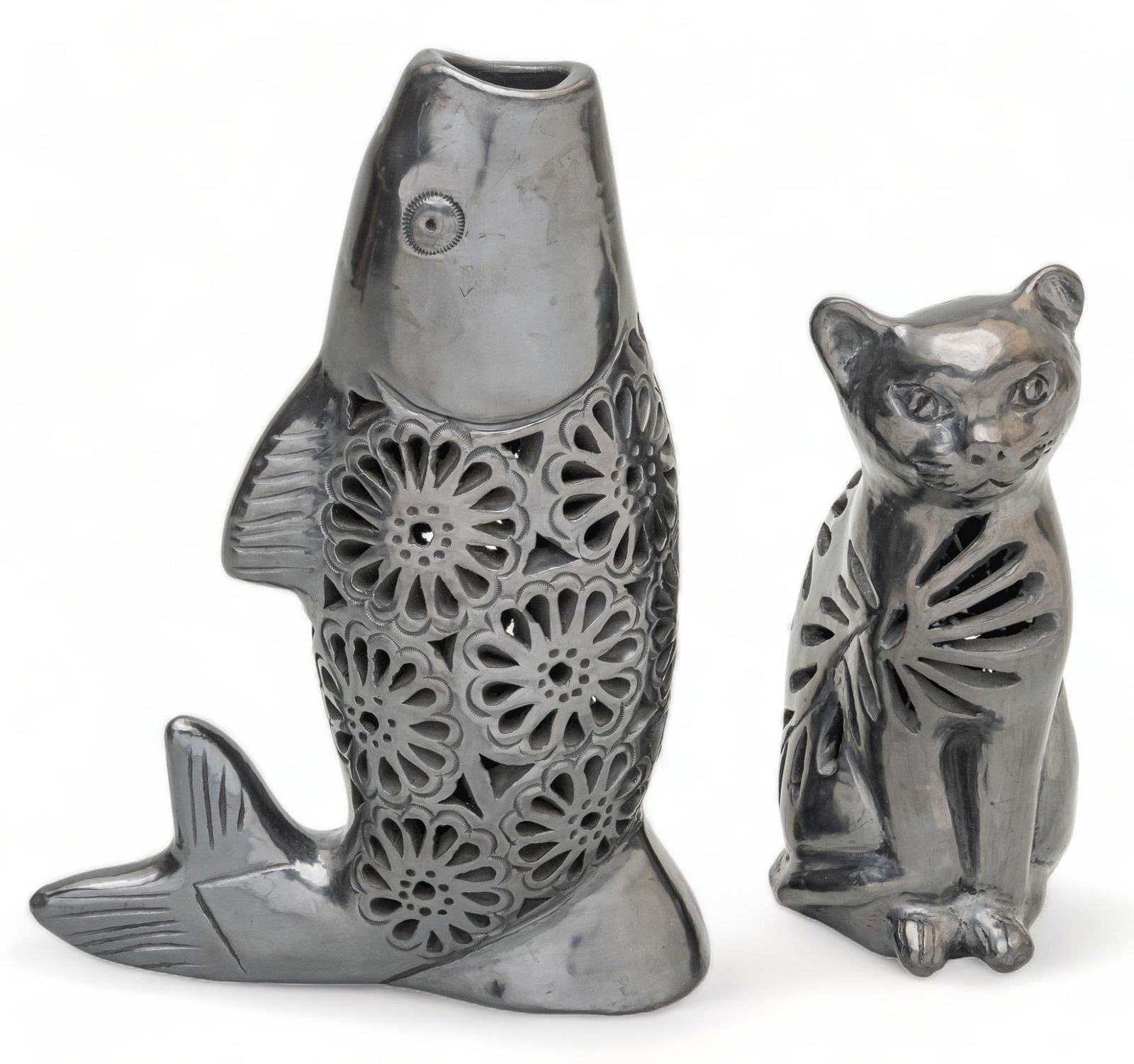 Dona Rosa, Barro Negro Cat and Fish luminaries: Dona Rosa, barro negro luminaries, molded and pierced clay, with incised accents, featuring one in the shape of a cat, one in the form of a cat height 10.75 in. x width 7.5 in. x depth 3 in. Provena