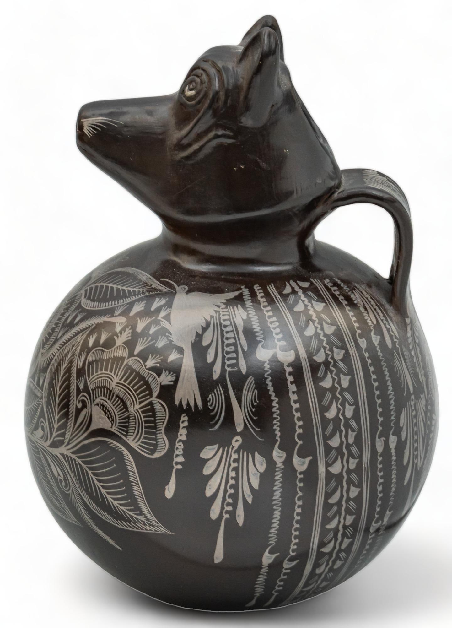 Coyote Portrait Vessel: Coyote portrait vessel, with stirrup handle, hand-painted glazed accents, featuring modeled detailing, coyote head height 11 in. x diameter 9 in. Provenance: Property from the life-long Mexican folk a