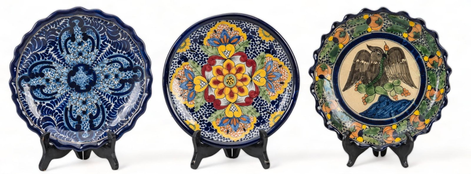 Group of (3) La Corona Talavera Chargers: Group of three La Corona Talavera chargers, with hand-painted glazed decoration, to include one blue and white plate, one blue, white, and yellow, one featuring eagle and snake design, all marked on r