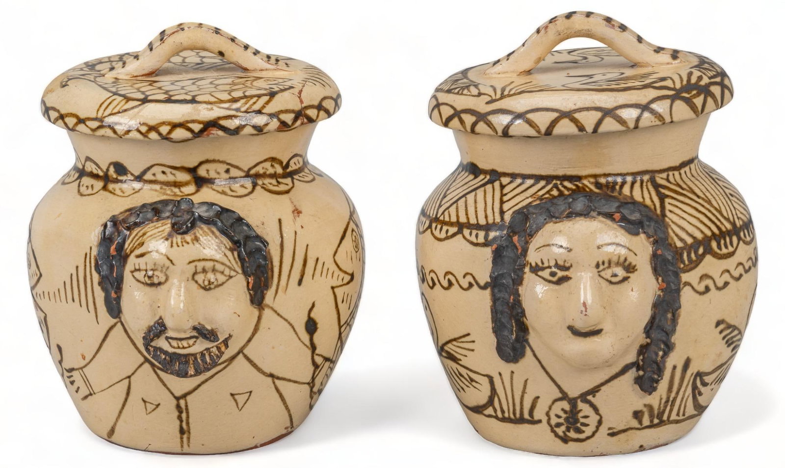 Pair of Portrait Jars: Pair of portrait jars (Tzintzuntzan, Michoacan), in the style of Consuela Rendon, featuring modeled clay portrait reliefs, painted brown glaze accents height 8 in. x width 6 in. x depth 8 in. Provenan
