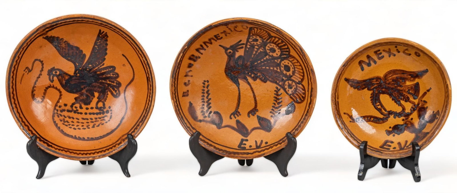 (3) Ceramic Chargers: Three ceramic chargers (Guanajuato, Mexico) each boasting unique design, with the first example featuring a rooter, with woven basket, above a winding snake, the second, featuring a peacock among bloo