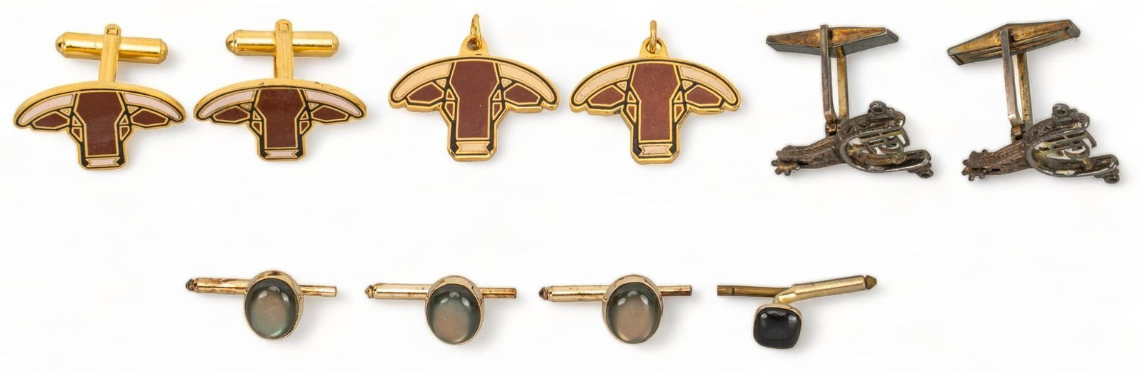 Bill Wittliff's Collection of Cufflinks: Collection of accessories owned by William D. Wittliff, includes pair of pendants and cufflinks with cattle design that was a design by Bill Wittliff that was used by the King Ranch, with three pairs
