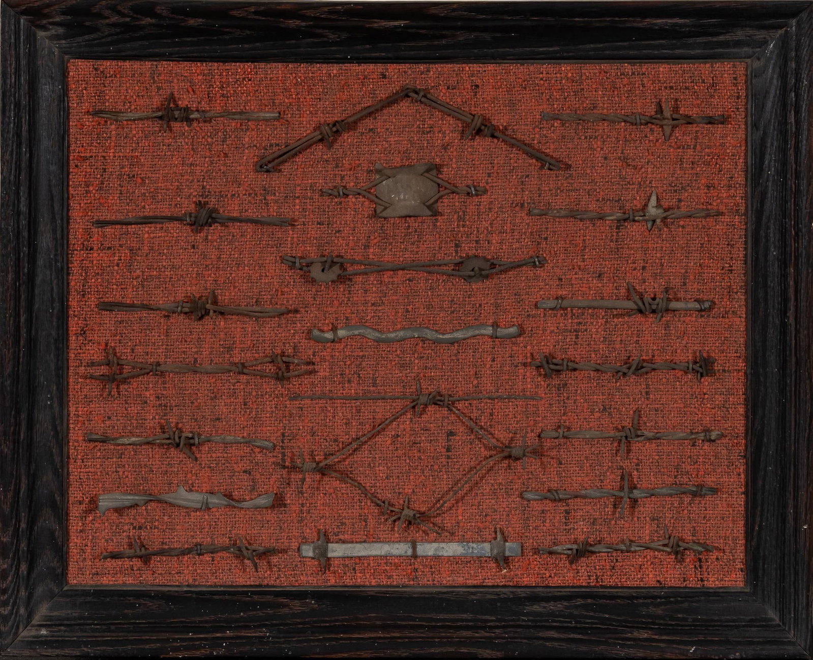 Framed Barbed Wire Display: Framed barbed wire display, featuring samples of various styles, supported on woven textile backing, framed height 21 in. x width 17 in. Provenance: Property from the personal estate collection of not