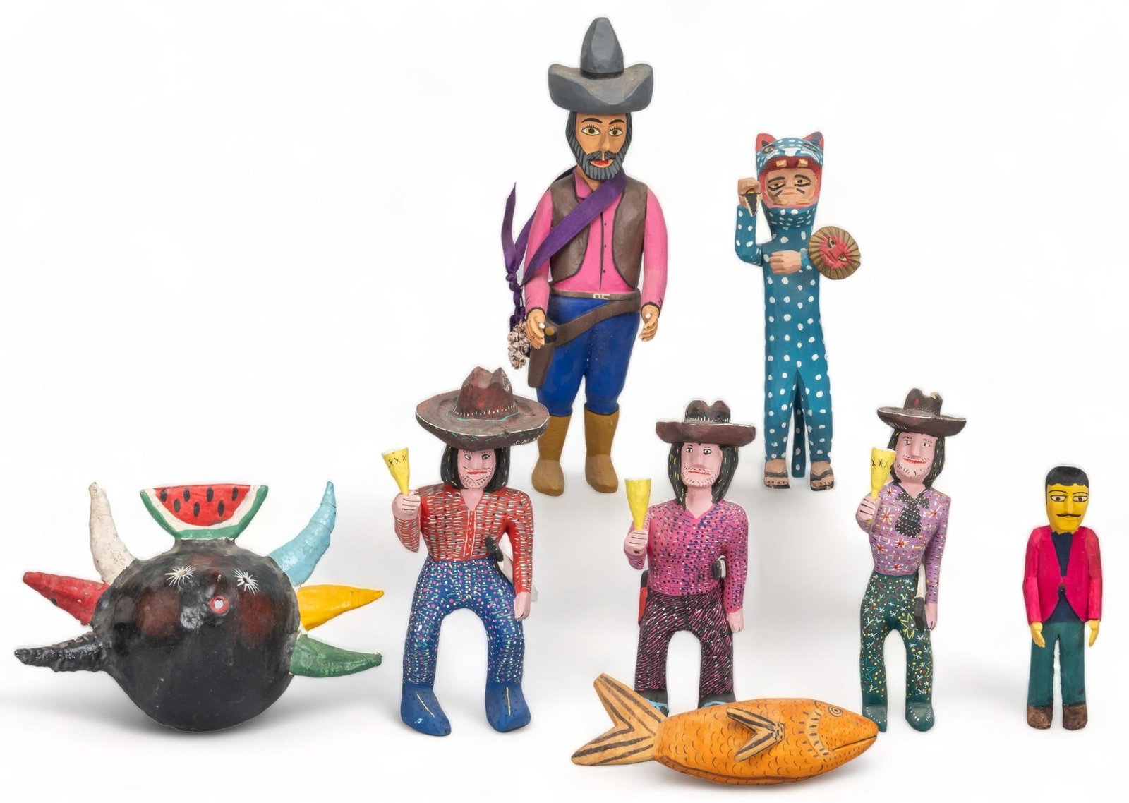 Collection of Mexican Folk Art: Collection of Mexican folk art, featuring one figure by Manuel Jimenez Ramirez, hand-carved and painted, depicting a vaquero, signed under foot, also to include one set of three Oaxacan style carved f