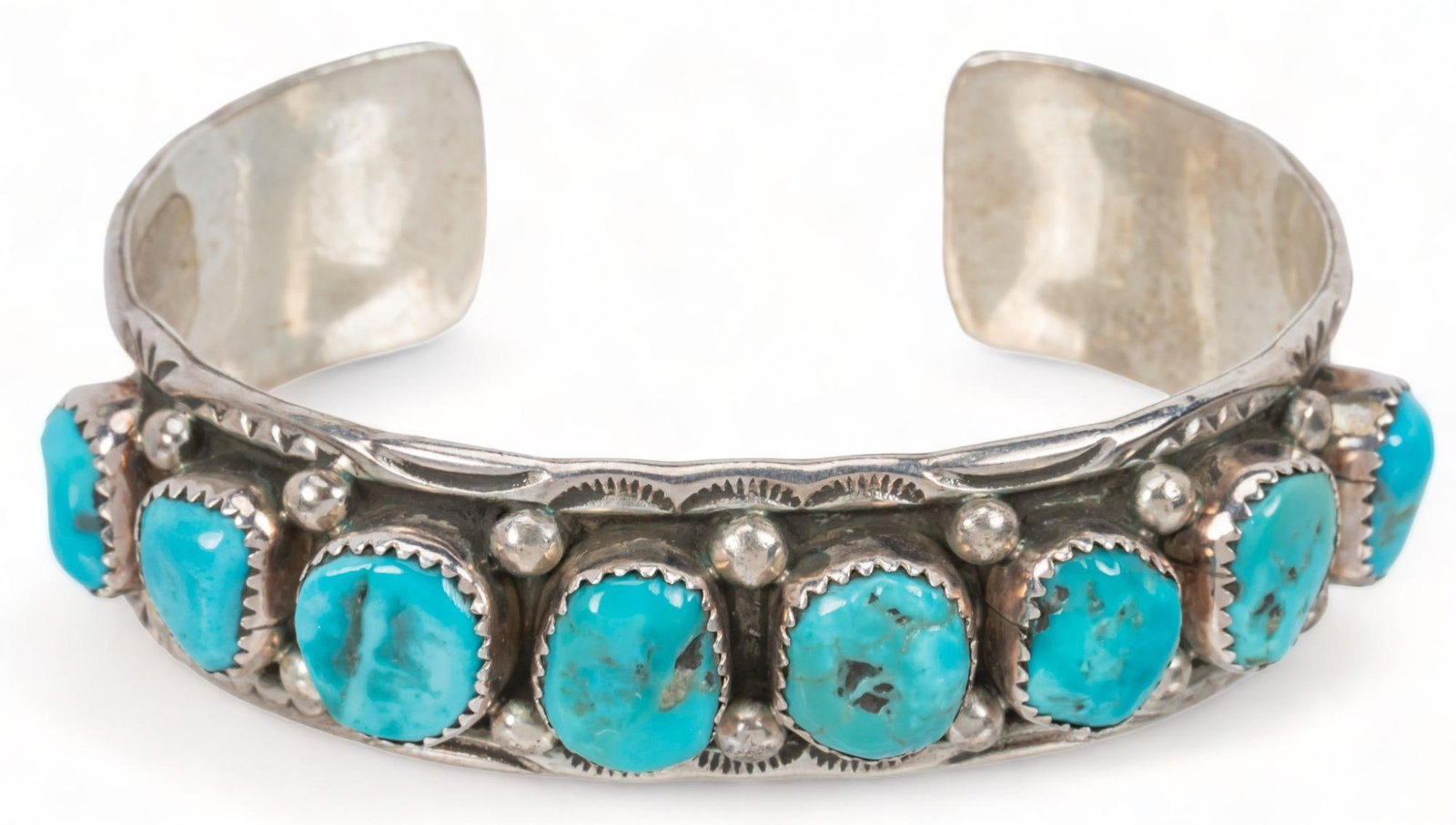 Native American Sterling Silver Turquoise Cuff: Native American sterling silver turquoise cuff, row of raised turquoise set stones, framed by etched silver bands and silver beads, marked "MT" circumference 7 in. total weight: 27.8 grams Pro