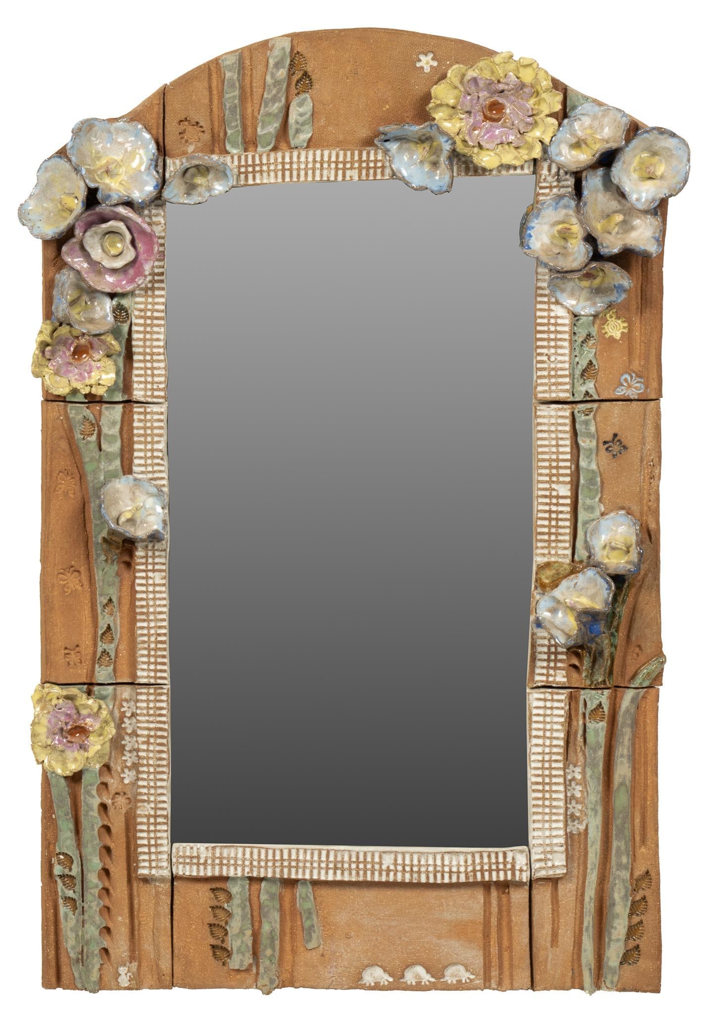 Ceramic Wall Mirror: Nancy Pawel style ceramic wall, featuring hand-modeled clay floral motifs, supporting rectangular mirror face, no signature detected height 32 in. x width 21 in. x depth 2.5 in. Provenance: Property f