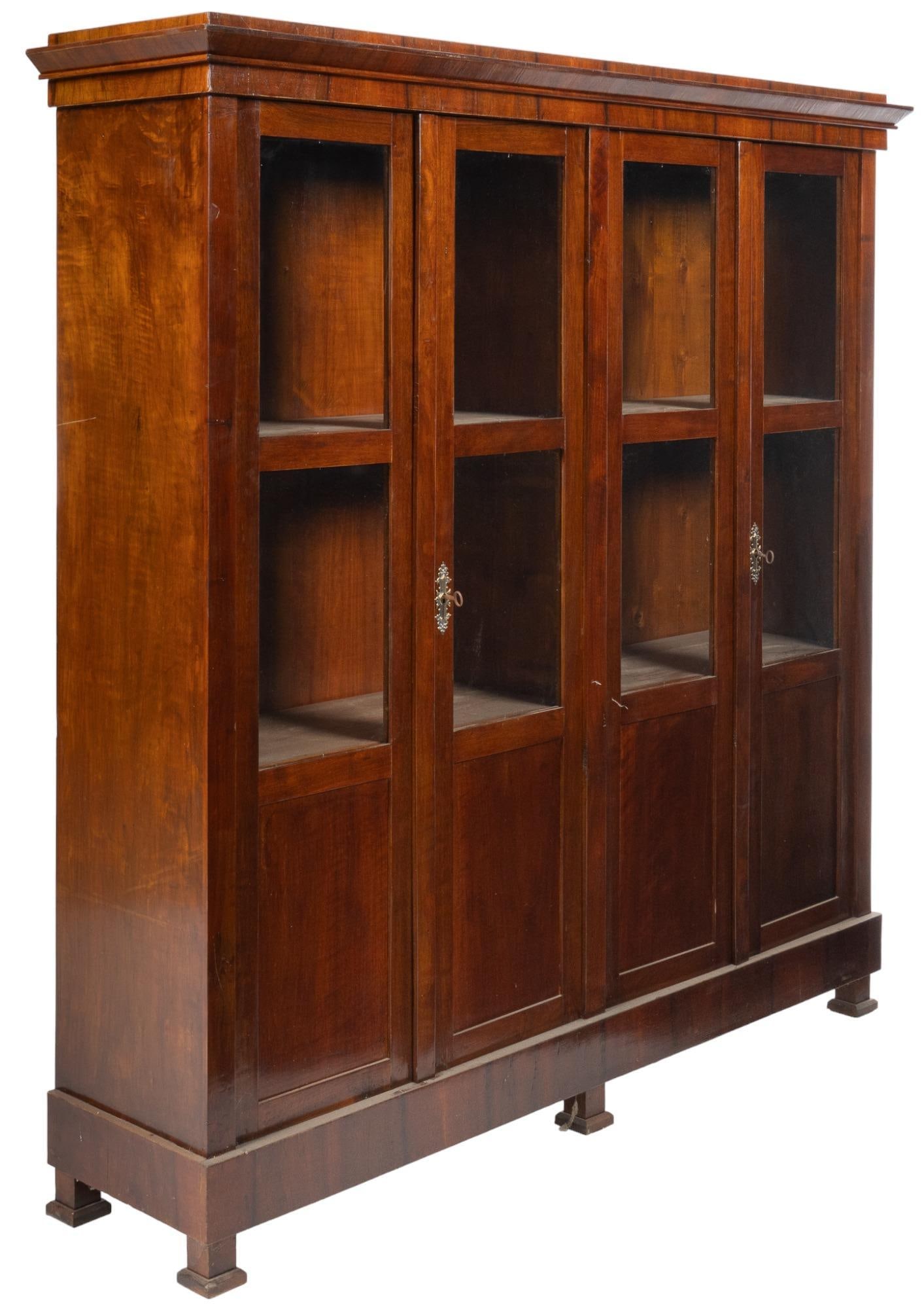 Vintage Library Bookcase: Large wooden library bookcase, four full-length glazed doors that open to a shelved interior, with keys height 71 in. x width 70 in. x depth 16.5 in. We happily provide seamless shipping services on e