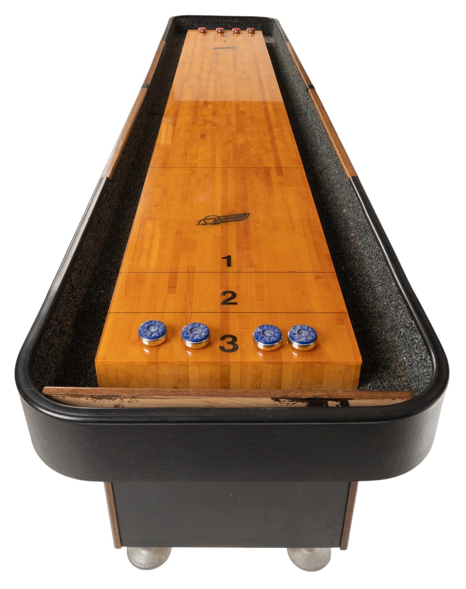 Dynamo Shuffleboard Table: Freestanding shuffleboard table, by Valley-Dynamo, three pedestal supports, includes 8 pucks height 33 in. x length 146 in. x width 31 in. Provenance: A Fredericksburg, Texas collection We happily pro