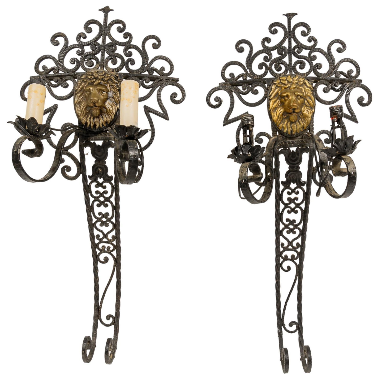 Pair of Iron Wall Sconces: Pair of iron wall sconces, featuring C-scroll motifs, brass lion heads, each supporting a single height 27 in. x width 15 in. x depth 12 in. / each Provenance: Property from a Spring Branch, Texas col