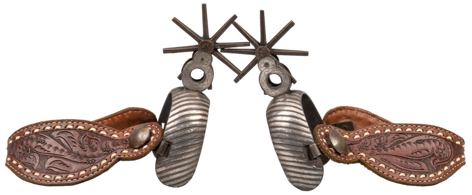 Pair of Mexican Chihuahua Spurs: Pair of early 1900's Mexican Chihuahua spurs, with tooled silver inlay, and leather heel straps with carved design spur length: 5.25 in. x width 3.25 in. rowel diameter: 3.25 in. Provenance: Prope