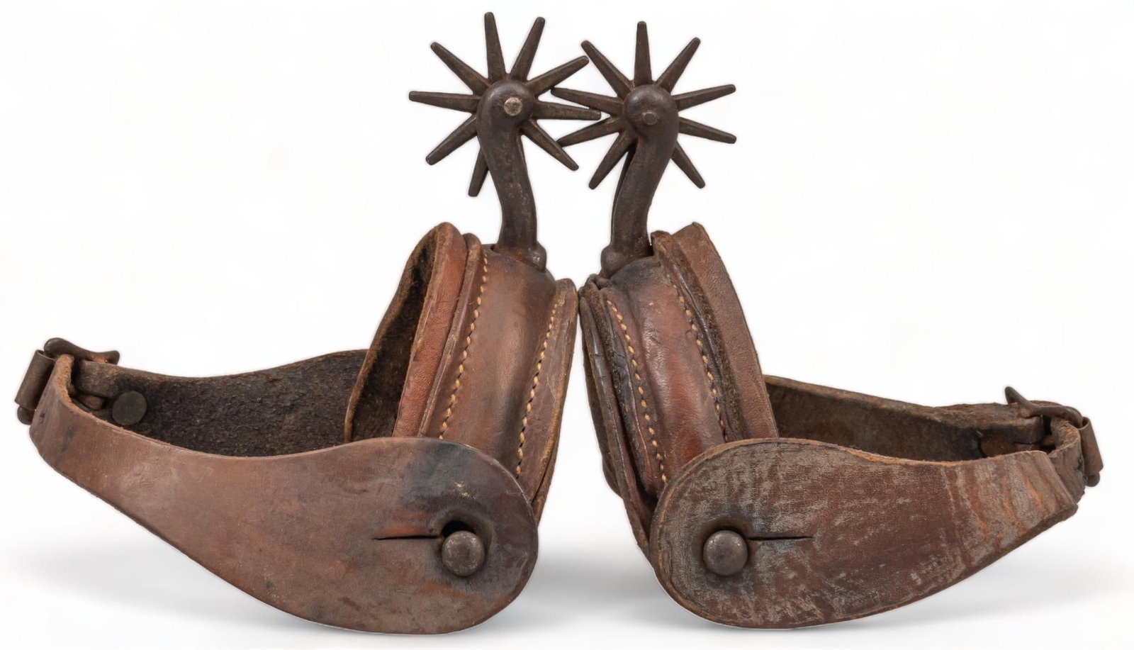 Leather Wrapped Cowboy Spurs: Pair of North and Judd early style leather wrapped cowboy spurs, with metal rowels spur length: 3.5 in. x heel width 3.75 in. rowel diameter: 2 in. Provenance: Property from a home in the Alamo Height