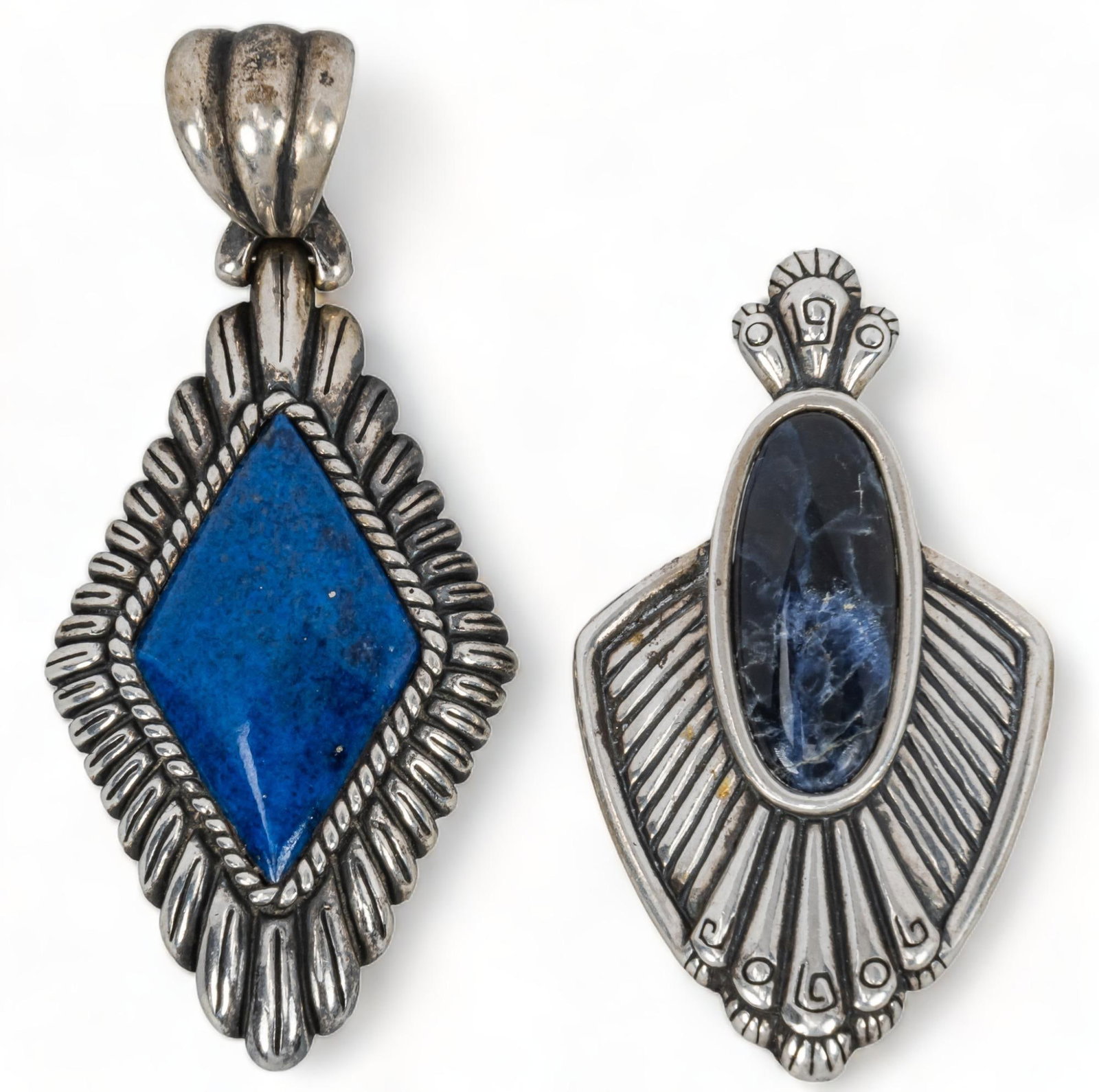 (2) Carolyn Pollack Sterling Silver Pendants: Two (2) Carolyn Pollack sterling silver pendants, one (1) sodalite cabochon pendant with lower silver design, one (1) silver border diamond shaped lapis stone pendant, marked sodalite pendant / length
