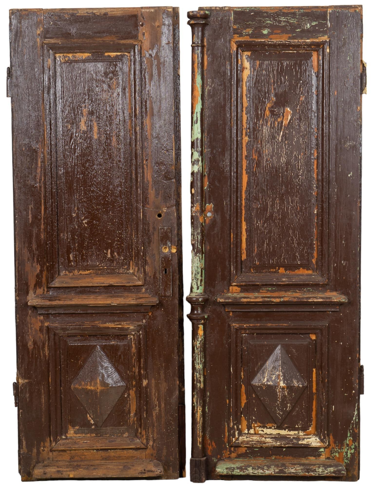 Pair of Primitive Doors: Matched pair of primitive wooden architectural doors, paneled, carved, distressed finish height 81.5 in. x width 56 in. x depth 2 in. / each We happily provide seamless shipping services on everything
