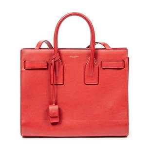 Yves Saint Laurent Sac De Jour Handbag: Yves Saint Laurent small Sac De Jour handbag of red calfskin leather with red leather handles, and gold tone hardware; marked DMR355153.1014, includes cadendas in clochette, keys, shoulder strap, and