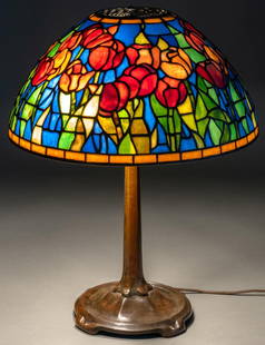 Signed Tiffany Stained Glass Tulip Table Lamp: Stained glass tulip lamp, with leaded stained glass dome shade, opalescent accents, marked Tiffany Studios New York on shade, with three bulb paddle sockets, marked Bryant, supported on bronze base, w