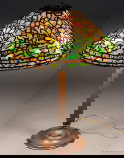 Signed Tiffany Stained Glass Botanical Table Lamp: Stained glass table lamp, with stained slag glass cone shade, marked Tiffany Studios New York, with three bulb paddle sockets, marked Bryant, supported on bronze architectural base, with areas of natu
