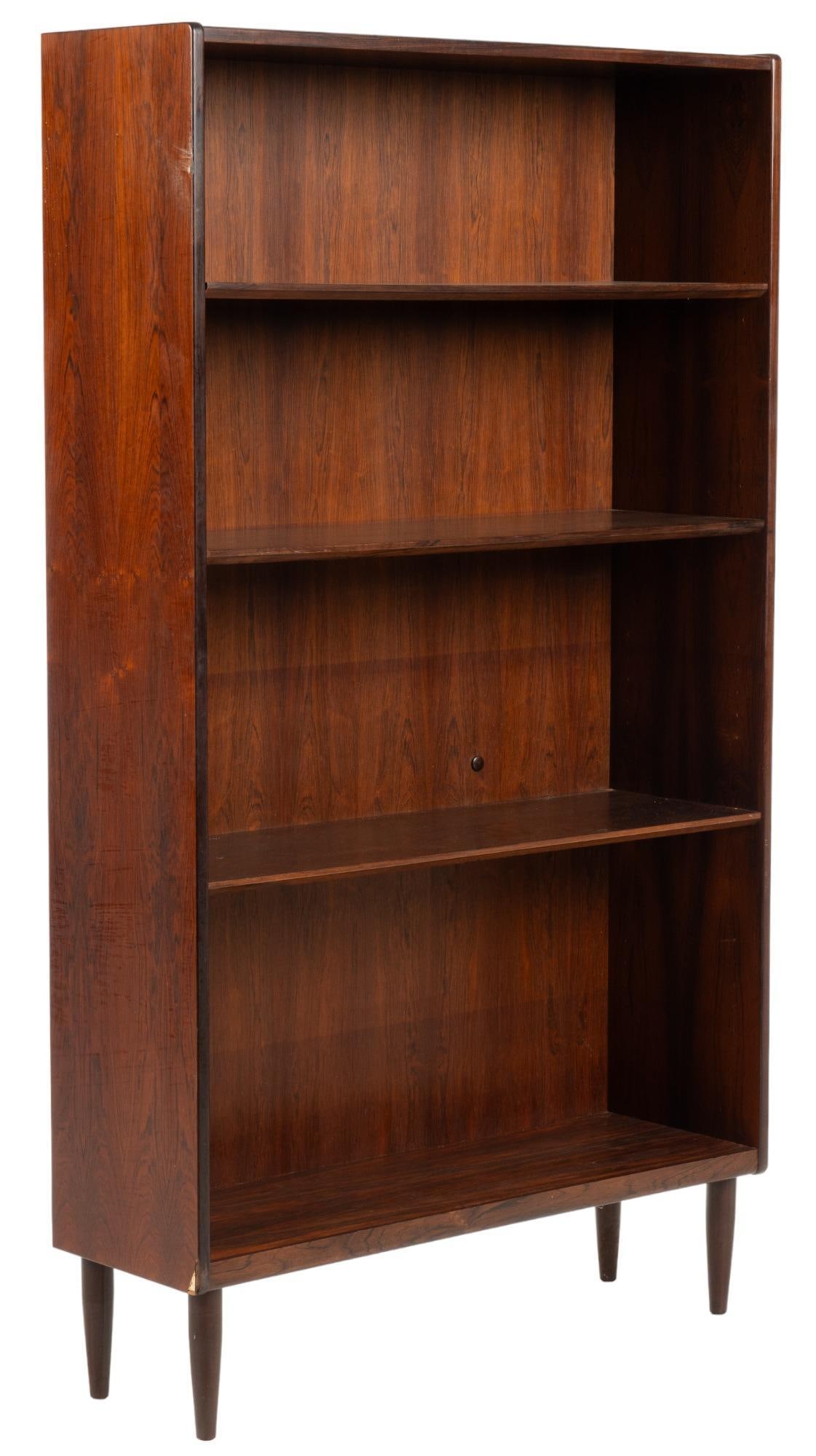 Danish Mid-Century Bookshelf: Danish Mid-Century bookshelf, with three shelves, supported on pin legs height 69.5 in. x width 39.5 in. x depth 12.5 in. We happily provide seamless shipping services on everything we sell. Please em