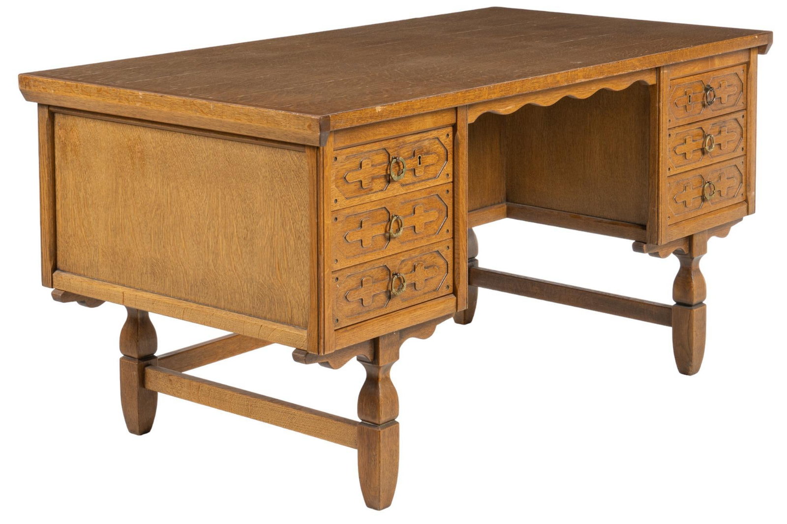 Danish Mid-Century Knee Hole Desk: Danish Mid-Century knee hole desk with oversize rectangular top above knee hole space, flanked by three stacked drawers with carved design and metal rings pulls, with carved drop door on reverse side,