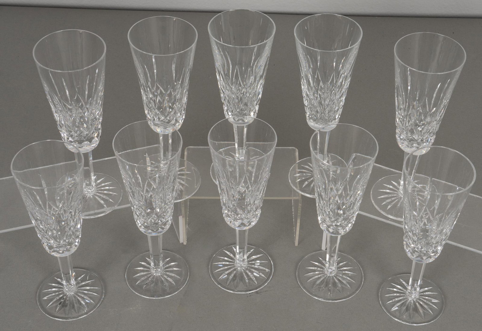 Set of (10) Waterford "Lismore" Champagne Flutes: Set of ten crystal champagne flutes by Waterford, in the "Lismore" pattern, marked on base Provenance: Property from the estate of a Seguin, Texas lady Shipping available for this lot through 
