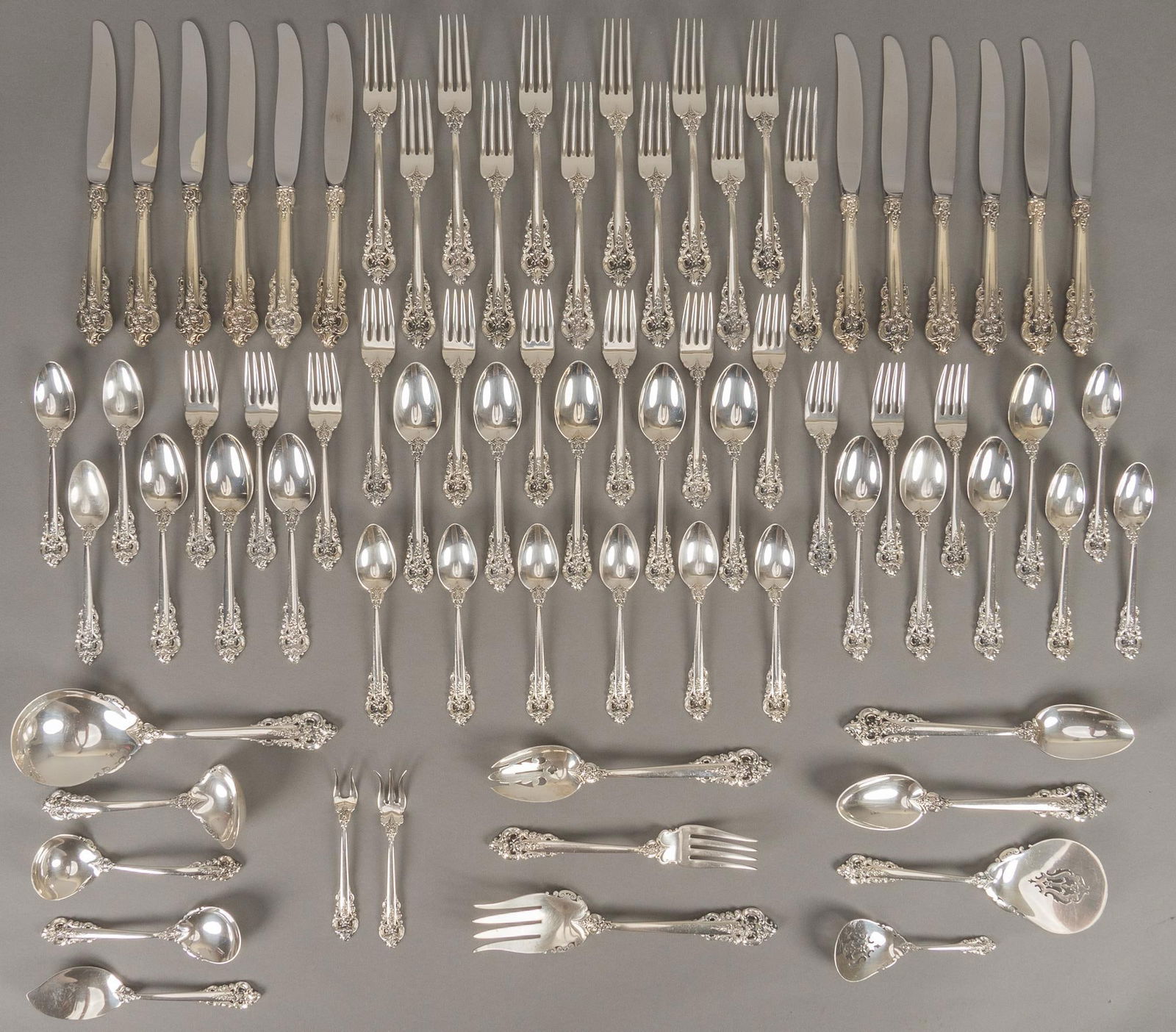 "Grande Baroque" by Wallace 75 Piece Sterling Flatware Set: "Grand Baroque" by Wallace Silversmiths sterling silver flatware, no monogram or removal, marked, seventy-five pieces total, to include: 12 dinner knives, 9 7/8 in. 12 dinner forks, 8 in. 12