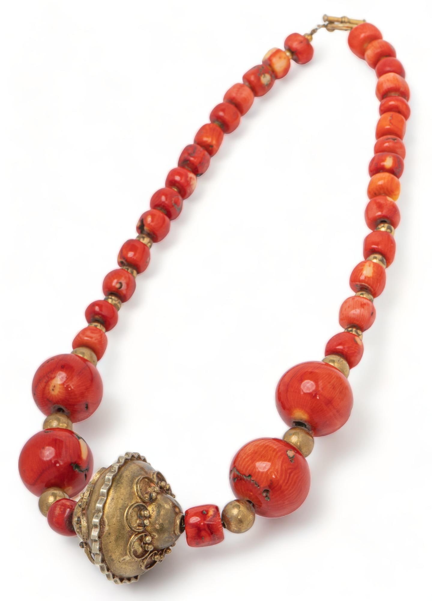 C. 1850 - 1880 Antique Coral and Gold Bead Necklace: Antique coral and gold bead necklace, central ornate handcrafted gold filled bead, tubular beads, small gold beads central bead / length 37 mm. length 21 in. Provenance: Property from the estate of a 