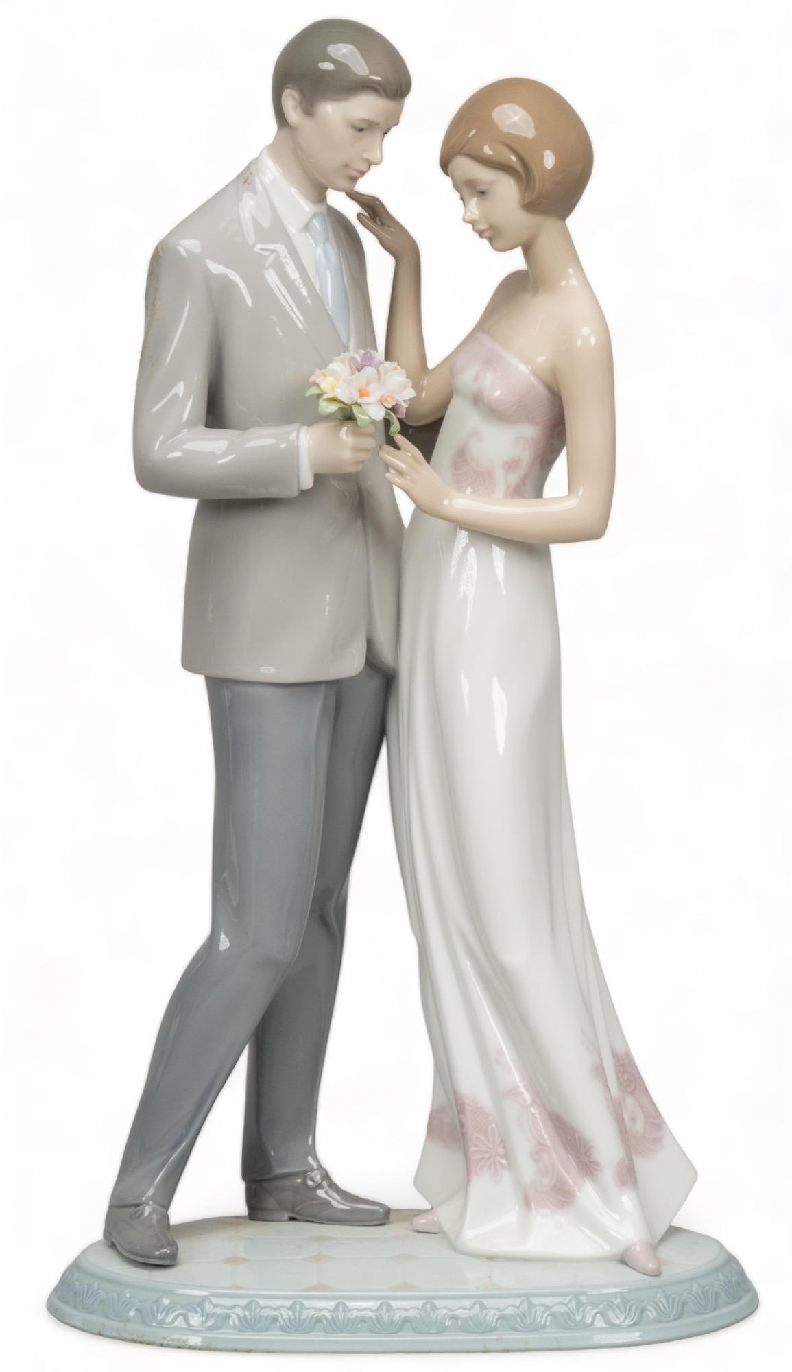 Lladro "Declaration of Love" Figurine: Lladro Declaration of Love glossy porcelain figurine of couple, with a small bouquet of flowers, model 6957, marked with maker and serial number on bottom height 13.5 in. x width 7.5 in. x depth 5 in.