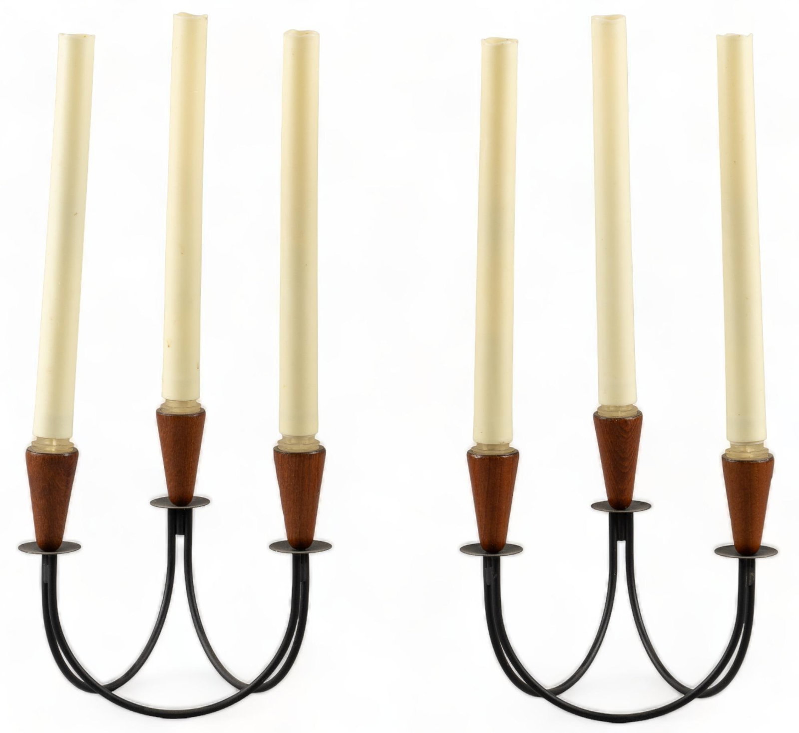 Pair of Mid-Century Candelabras: Pair of Mid-century candelabras, curved metal bases, each with three faux tapered candles, turned on and off by twisting faux candles height 15.5 in. x width 7 in. x depth 7 in. / each Provenance: Pro
