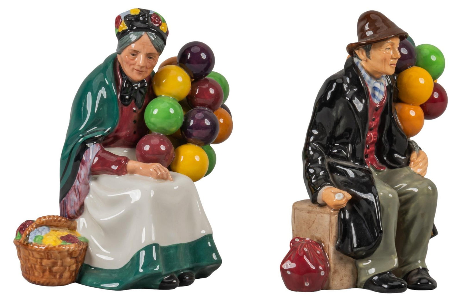 Pair of Royal Daulton Figurines: Pair of Royal Doultonceramic figurines, depicting "The Balloon Man" and the "Old Balloon Seller", marked on bases height 7 in. x width 5 in. x depth 4 in. / largest Provenance: Propert