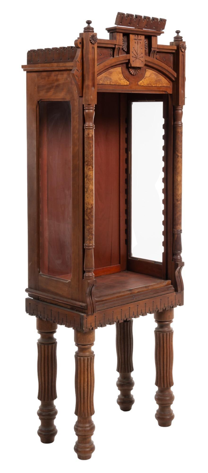 Eastelake Style Display Cabinet: Eastlake style display cabinet, with architectural accents, burlwood inlay, supported on flutedlegs height 73 in. x width 26.5 in. x depth 17 in. Provenance: Property from the estate of a San Antonio,