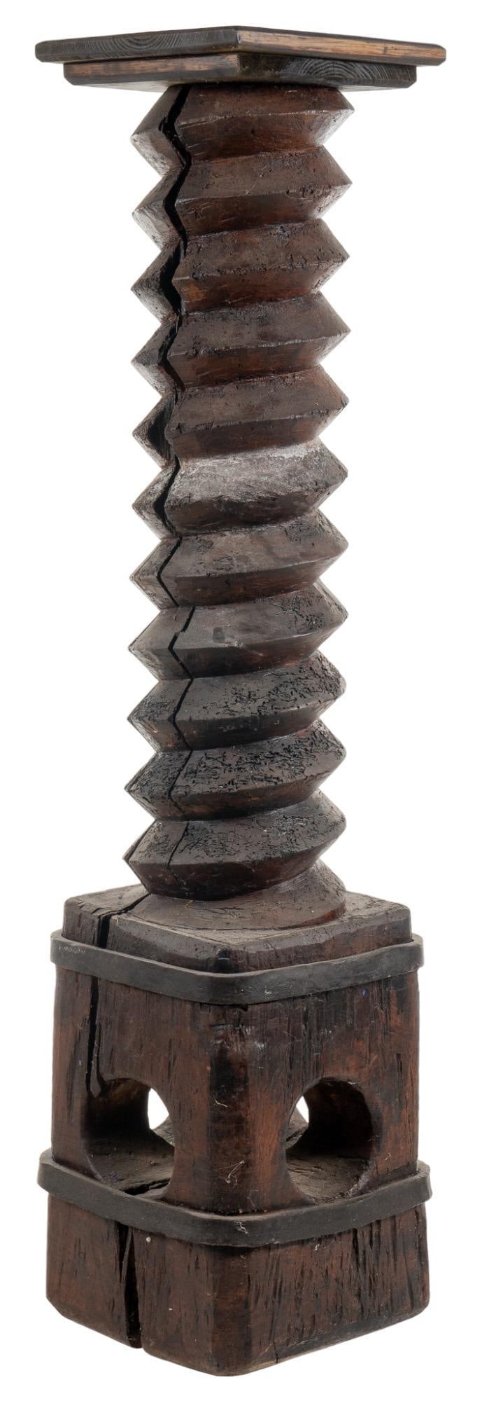 Wood Screw Sculptural Column: Carved wooden column display with screw / wine press design on based with metal banding height 62 in. x width 14 in. x depth 14 in. Provenance: Property from a Kerrville, Texas estate Shipping avai