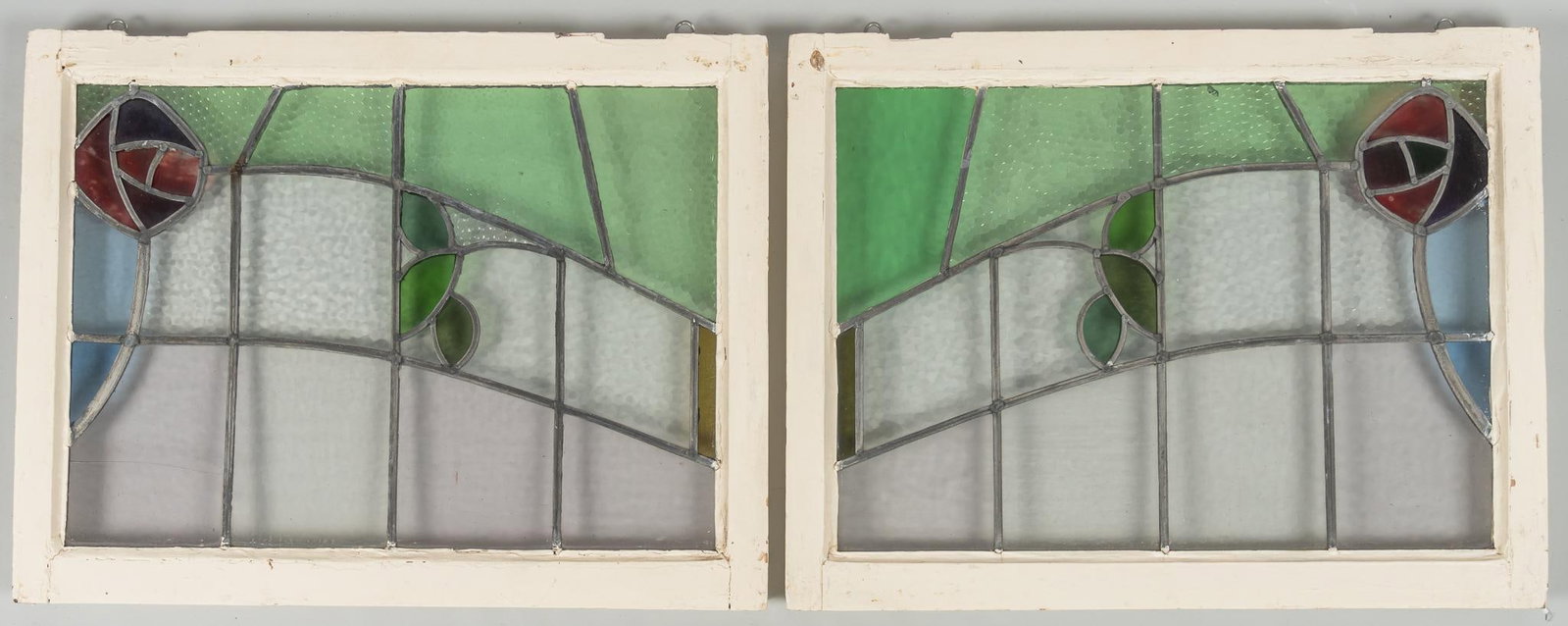 (2) Rosette Stained Glass Windows: Two (2) rosette stained glass windows, rosette corner design with leaf, leaded panes height 23 in. x width 29 in. x depth 2 in. Provenance: Property from the collection of a San Antonio, Texas gentlem