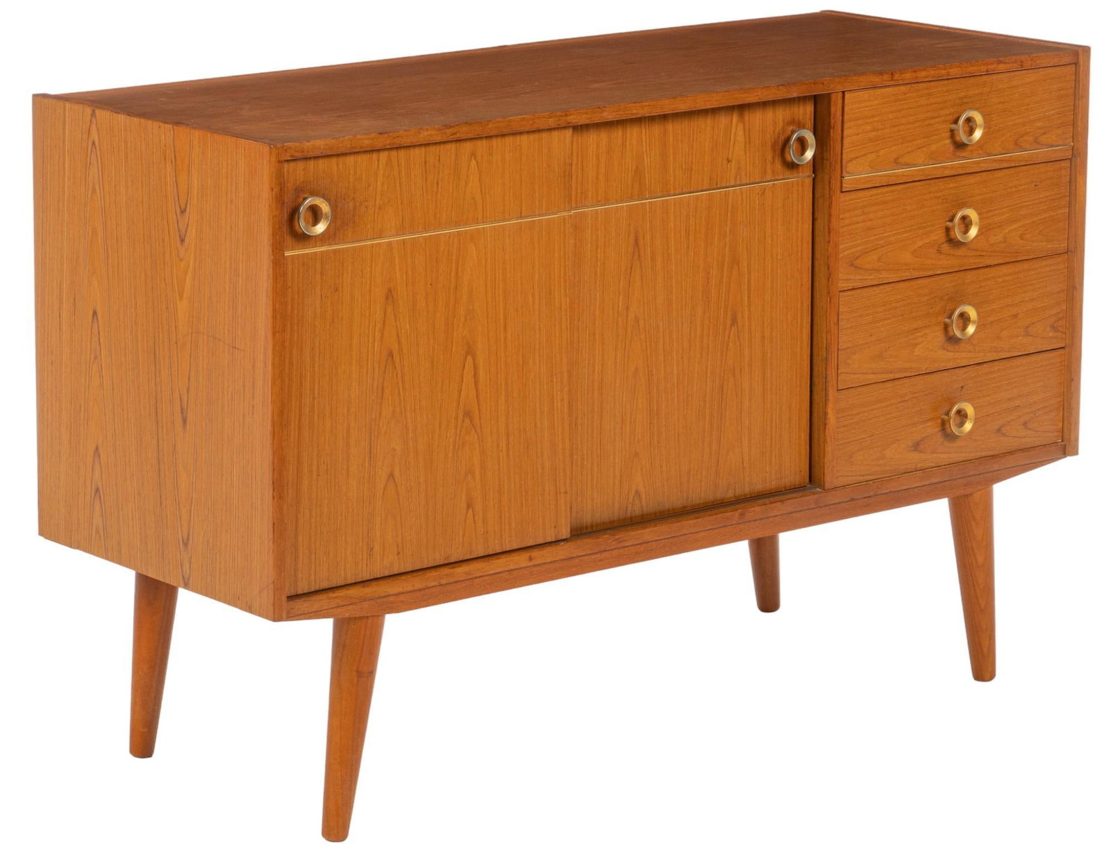 Danish Mid-Century Credenza: Danish mid-century credenza featuring pair of sliding cabient doors with gold-toned metal pulls, and accents, that open to reveal shelved interior storage, beside stack of four drawers with matching p