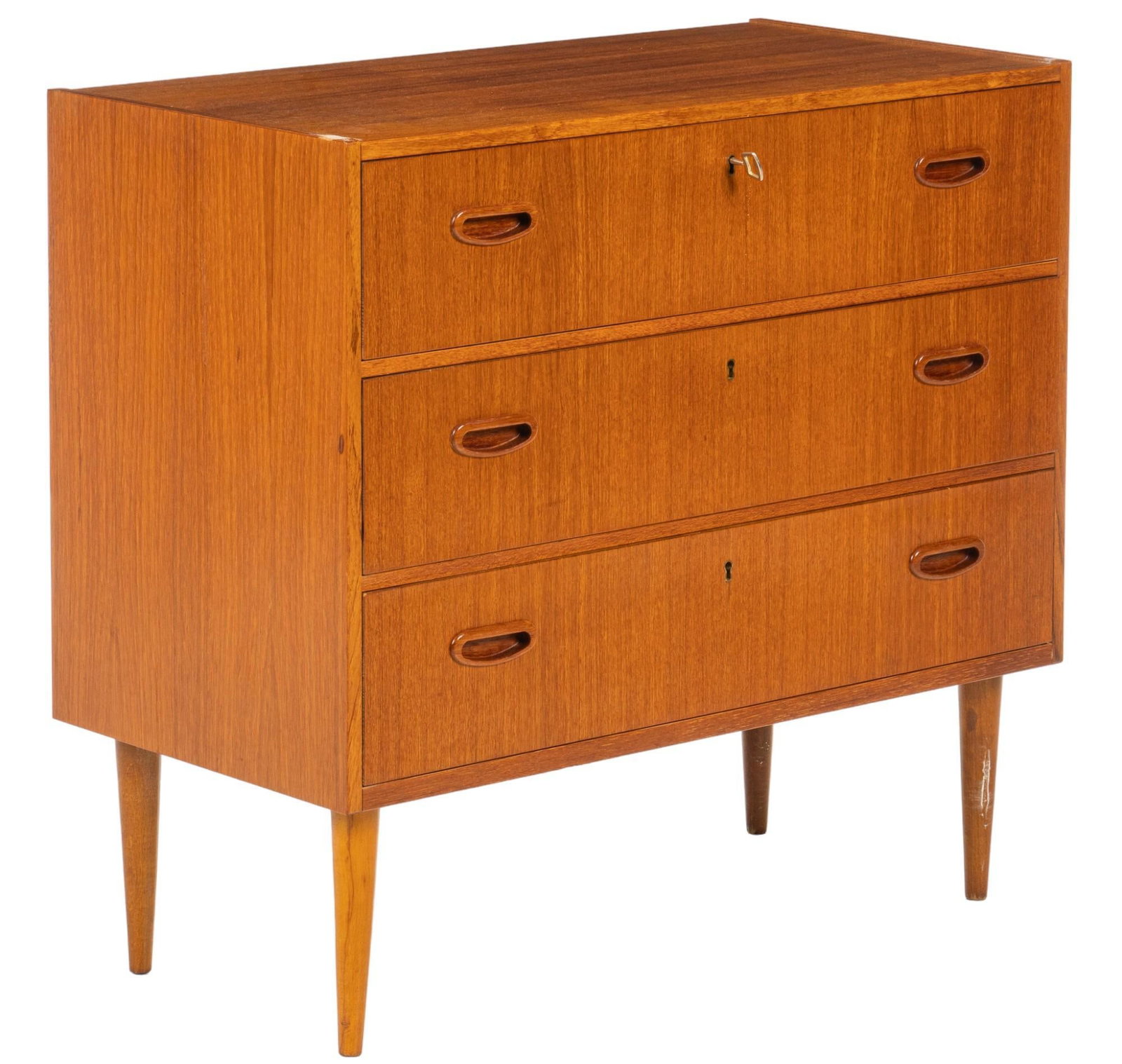 Danish Mid-Century Chest of Drawers: Danish mid-century chest of three stacked drawers with key lock, and integrated wood pulls, supported on pin legs, includes key height 28 in. x width 29.5 in. x depth 15 in. Shipping available for thi