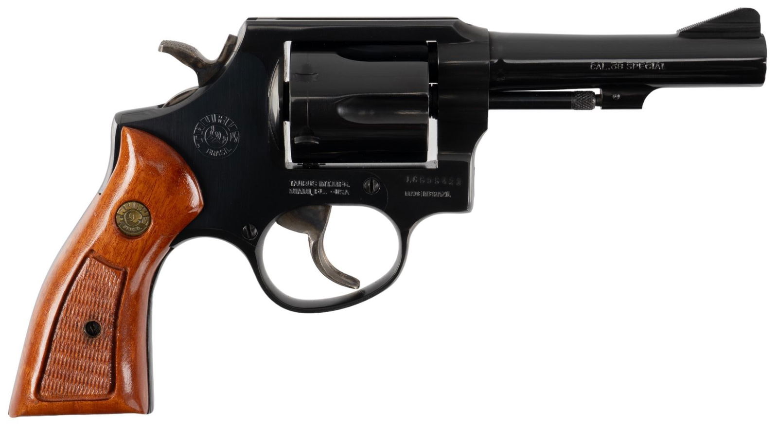 Taurus Model 80 38 SPL Revolver: Serial: LC595423 Manufacturer: Taurus-Brazil / Taurus Int. Mfg. Model: 80 Caliber: 38 SPL Barrel length: 4 in. OAL: 9.5 in. Condition: Very Good; wood grips have very light handling marks; barrel, fra