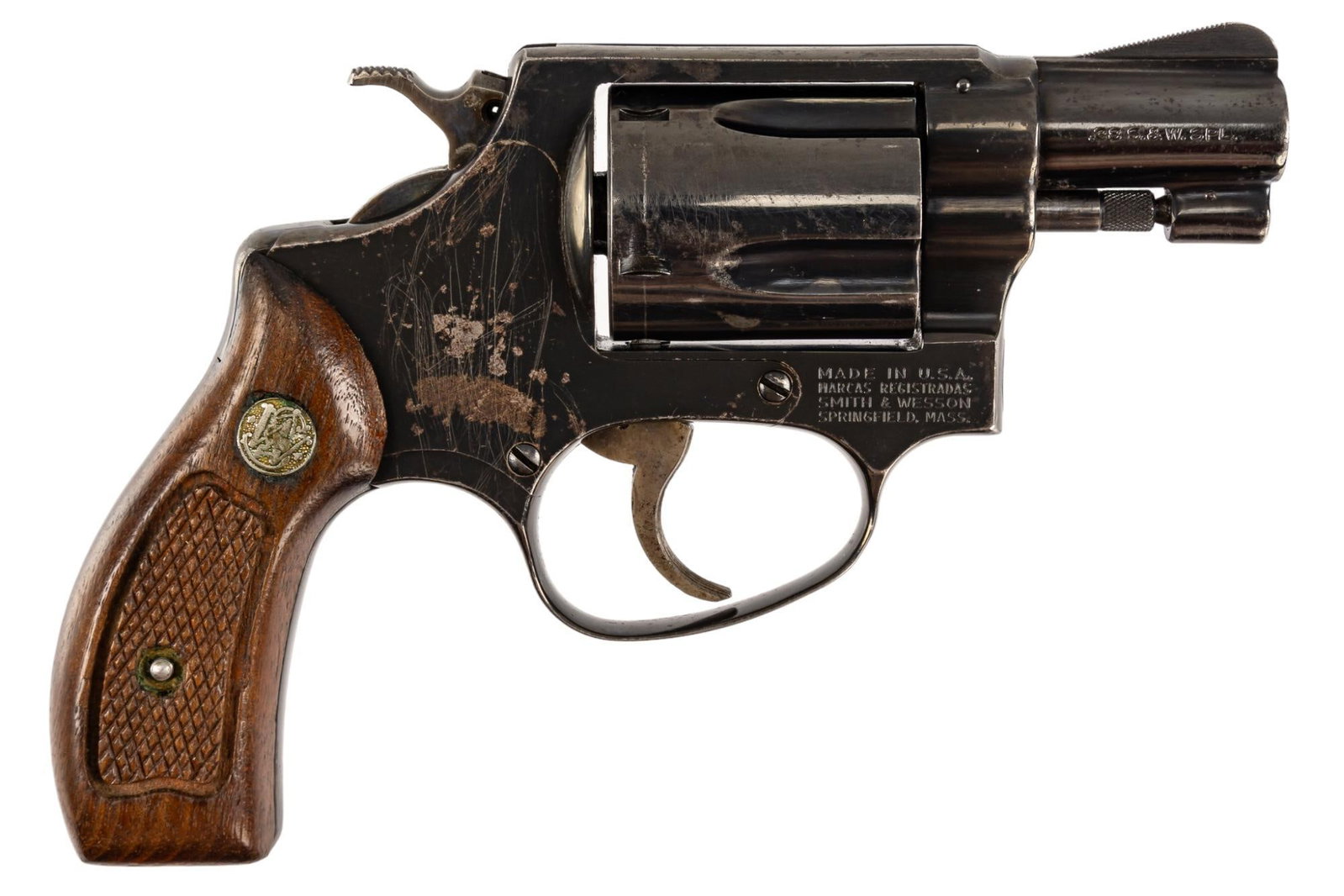 Smith & Wesson Model 36 38 Special Revolver: Serial: J802725 Manufacturer: Smith & Wesson Model: 36 Caliber: 38 SPL Barrel length: 1.875 in. OAL: 6.5 in. Condition: Fair; wood grips have moderate wear & patina; barrel, frame & cylind