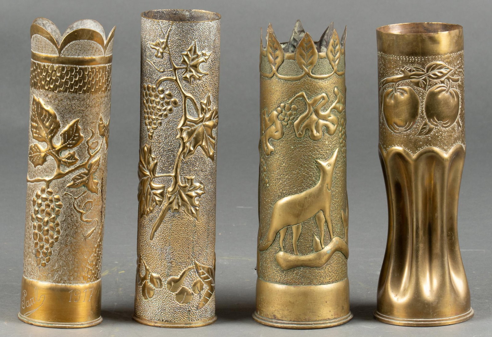 Set of 4 Grape Vine Engraved WWI Trench Art Vases: Includes: 2- French 75mm casings; both with grape vine engravings, one engraved "Paul 1917" 2- British 18 Pounder Casings; one featuring a fox among grape vines; one featuring apples Longest: 