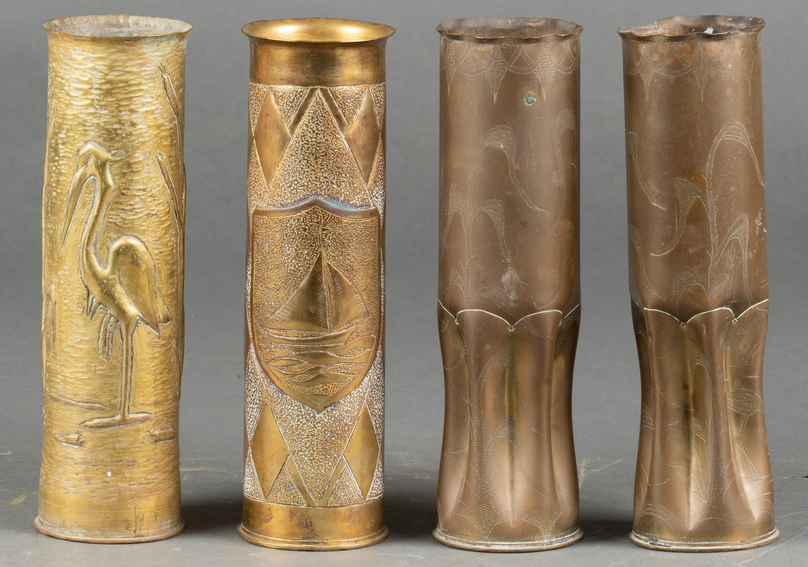 Set of 4 Nautical Engraved WWI & WWII Trench Art Vases: Includes: 4- French 75mm casings; one WWII era with a checkered background and a sailboat; and three WWI casings with cranes (one pair and a single) Longest: 12 in. Shipping available for this lot thr
