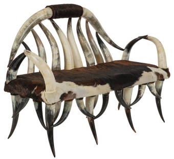 Steer Horn and Cowhide Sofa: Steer horn and cowhide twin seat chair / sofa, varying size steer horns constructing the frame with a brown cowhide headrest and seat height 42 in. x width 60 in. x depth 28 in. Provenance: