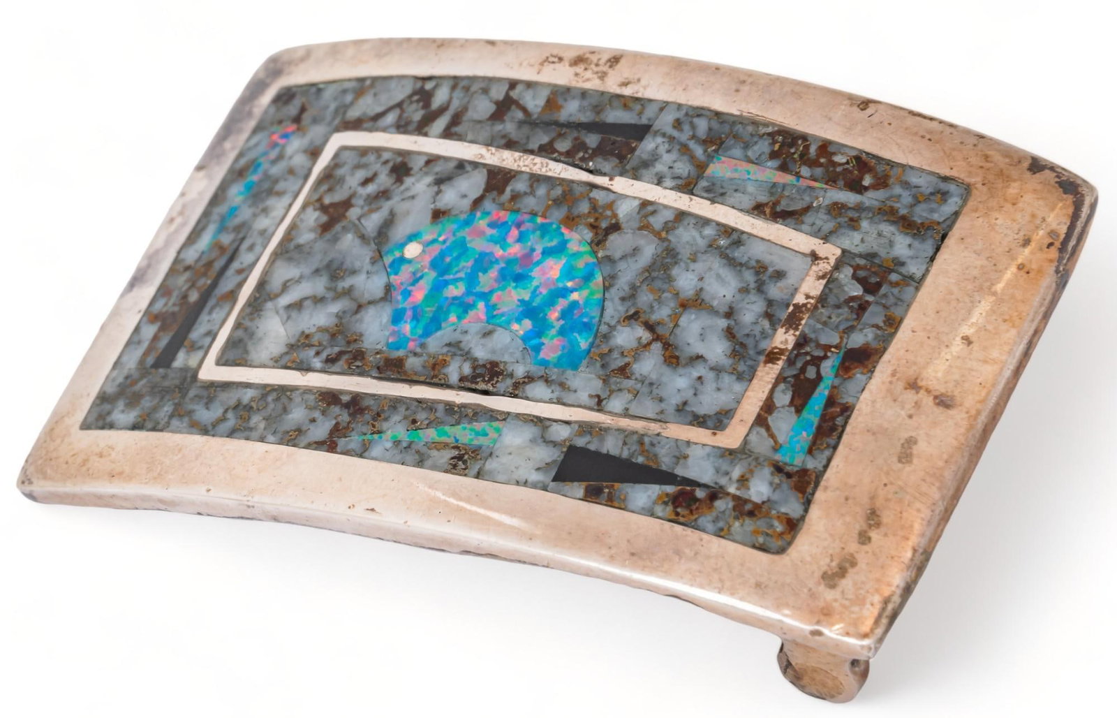 Stone Inlay Belt Buckle: Stone inlay belt buckle, gray stone background, angular stone design with blue stone accents, black triangle stone details, marked "GL Design" Provenance: Property from the estate of a Fair Oa