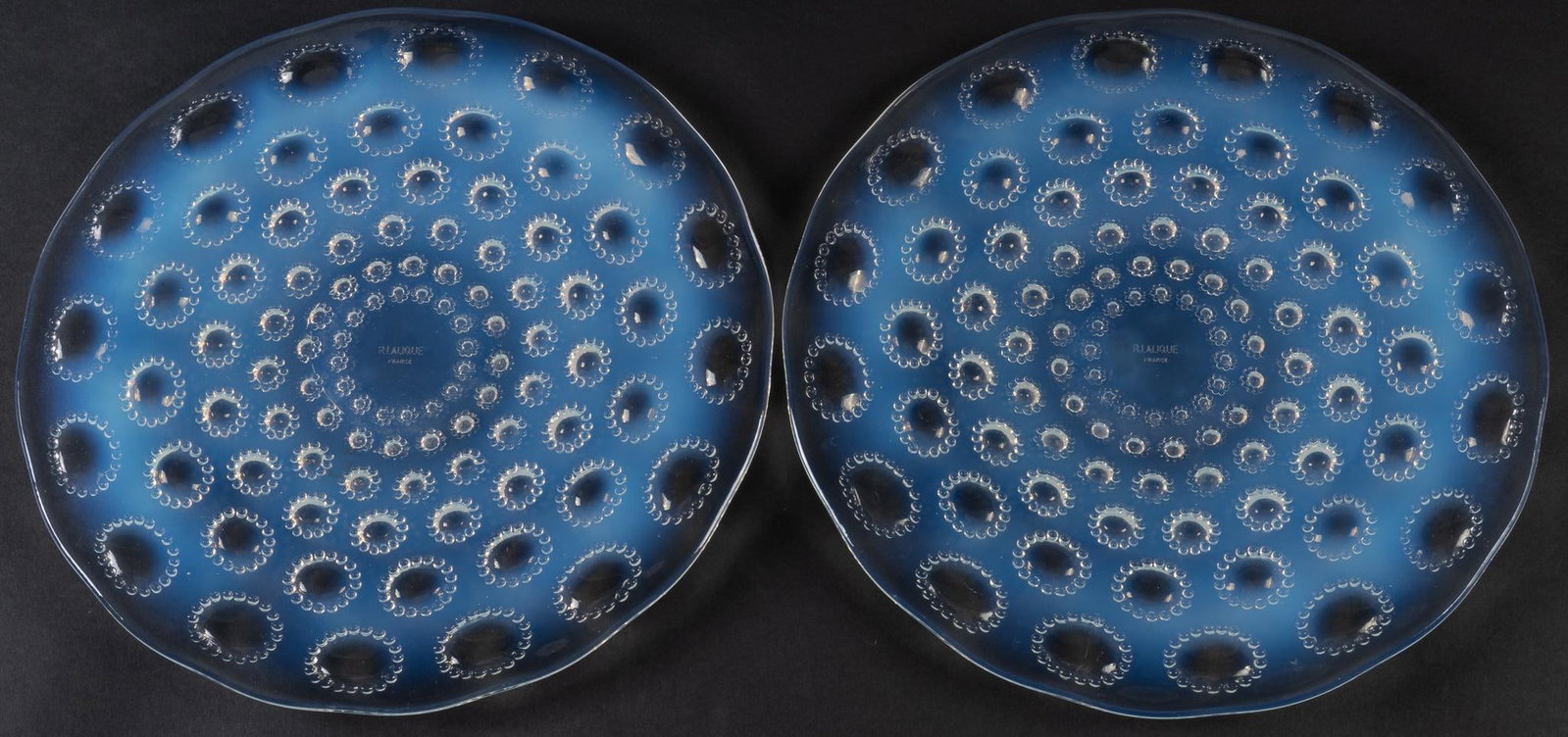 Rene Lalique Asters No 2 Opalescent Chargers: Pair of Rene Lalique France opalescent chargers from Asters line, singed "R. Lalique France", circa 1930s Diameter: 10.5 in Provenance: Property from a mansion in the Alamo Heights neighborhoo