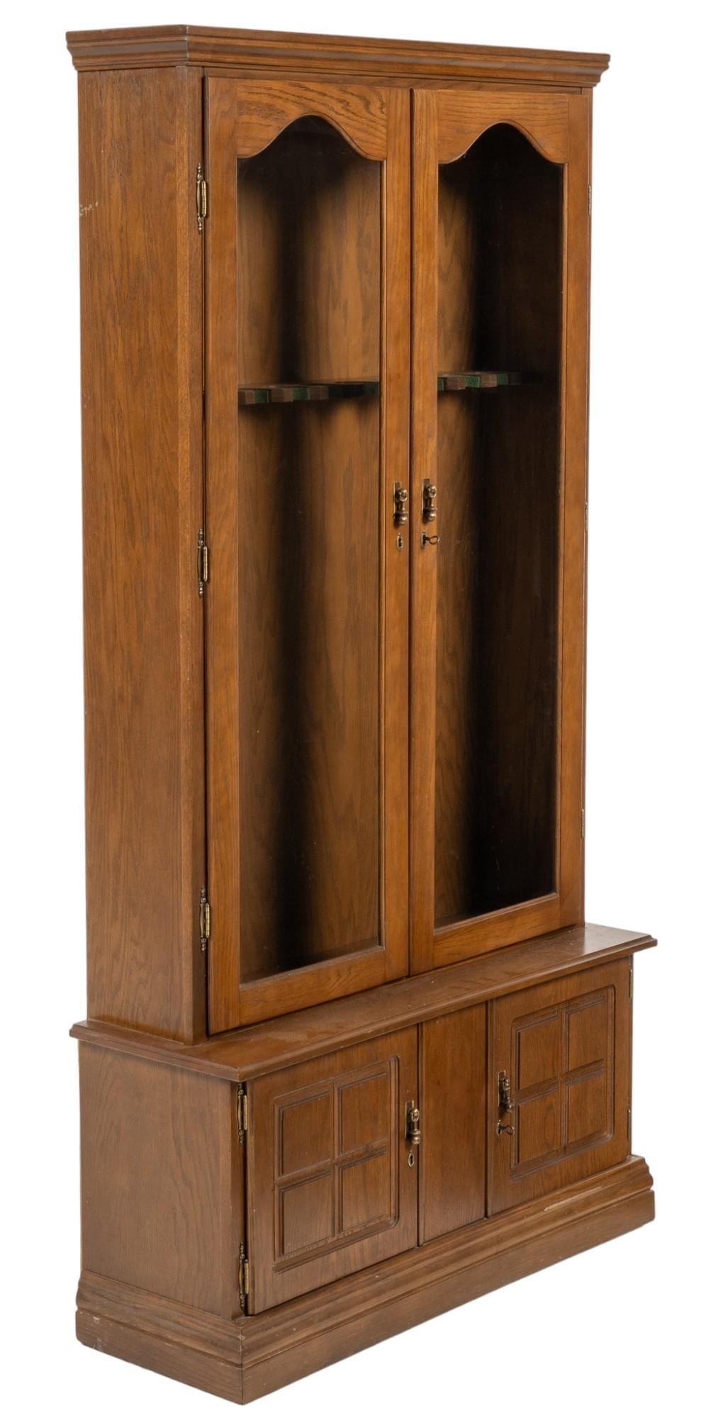 Gun Cabinet: Gun cabinet featuring pair of glass panel doors that open to interior rack with ten (10) divisions, above lower pair of cabinet doors that open to interior storage, includes two keys height 70 in. x w