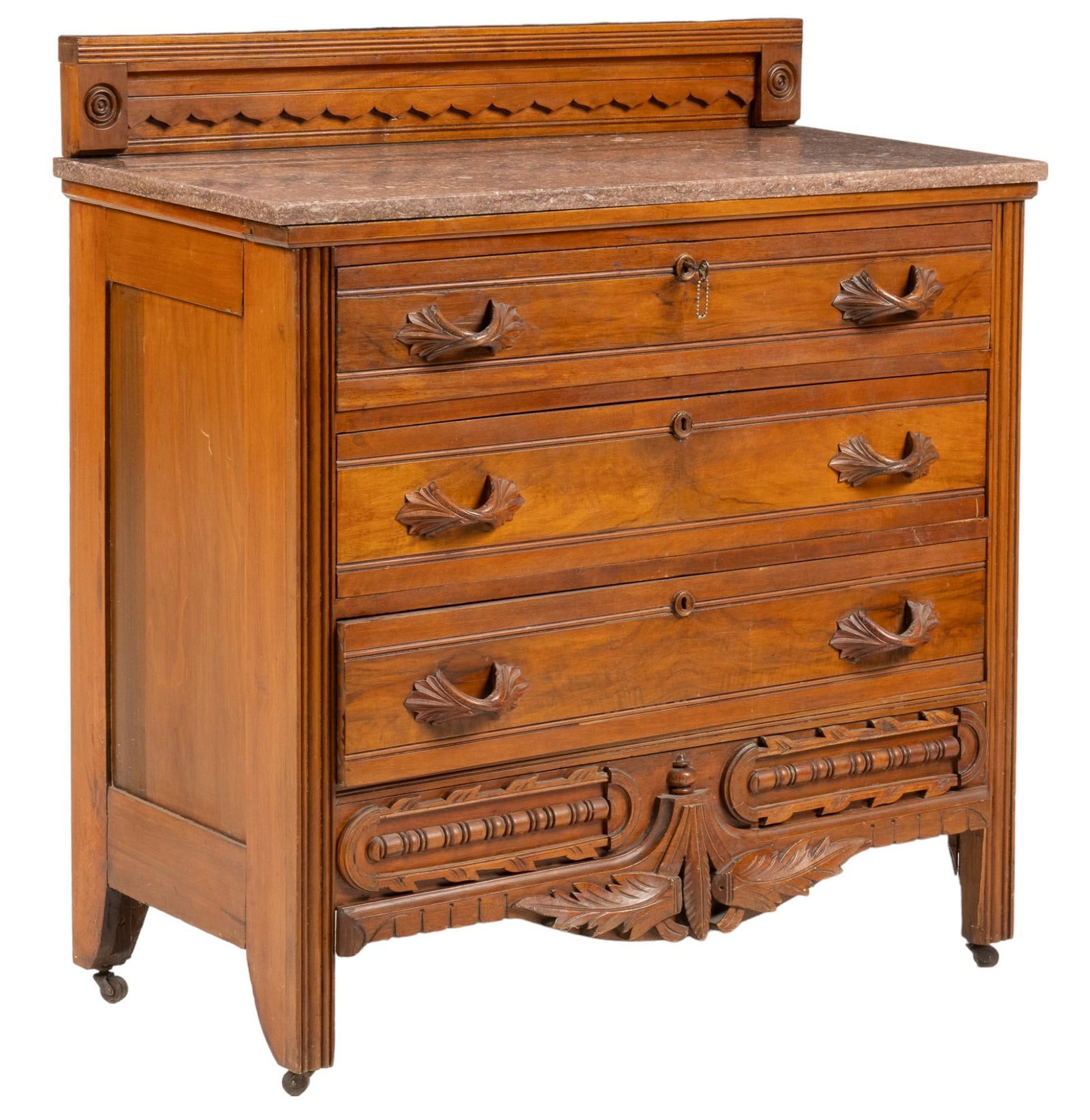 Marble Top Dresser: Wooden chest of drawers / dresser featuring carved gallery above marble top above stack of three drawers with carved wooden pulls, above carved apron featuring foliate motif, supported on casters, inc